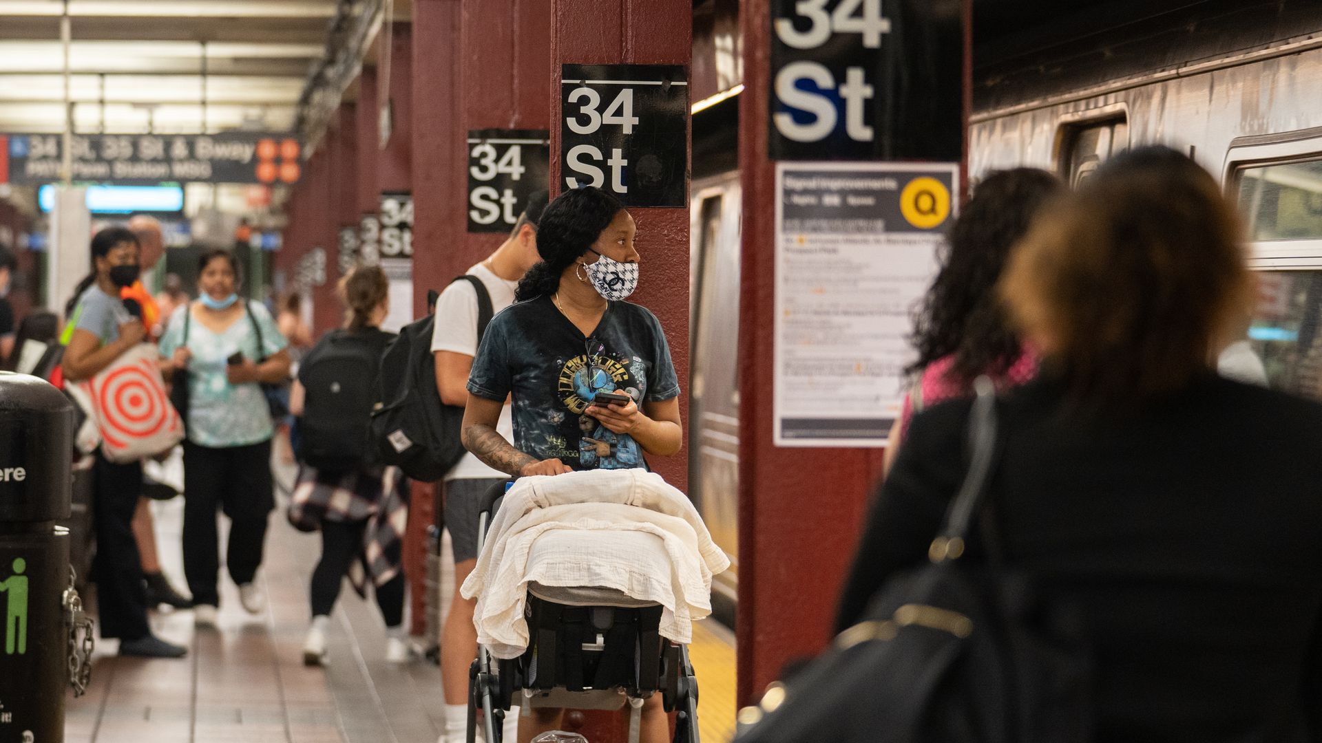Commuters wait on the platform of a subway station in New York.