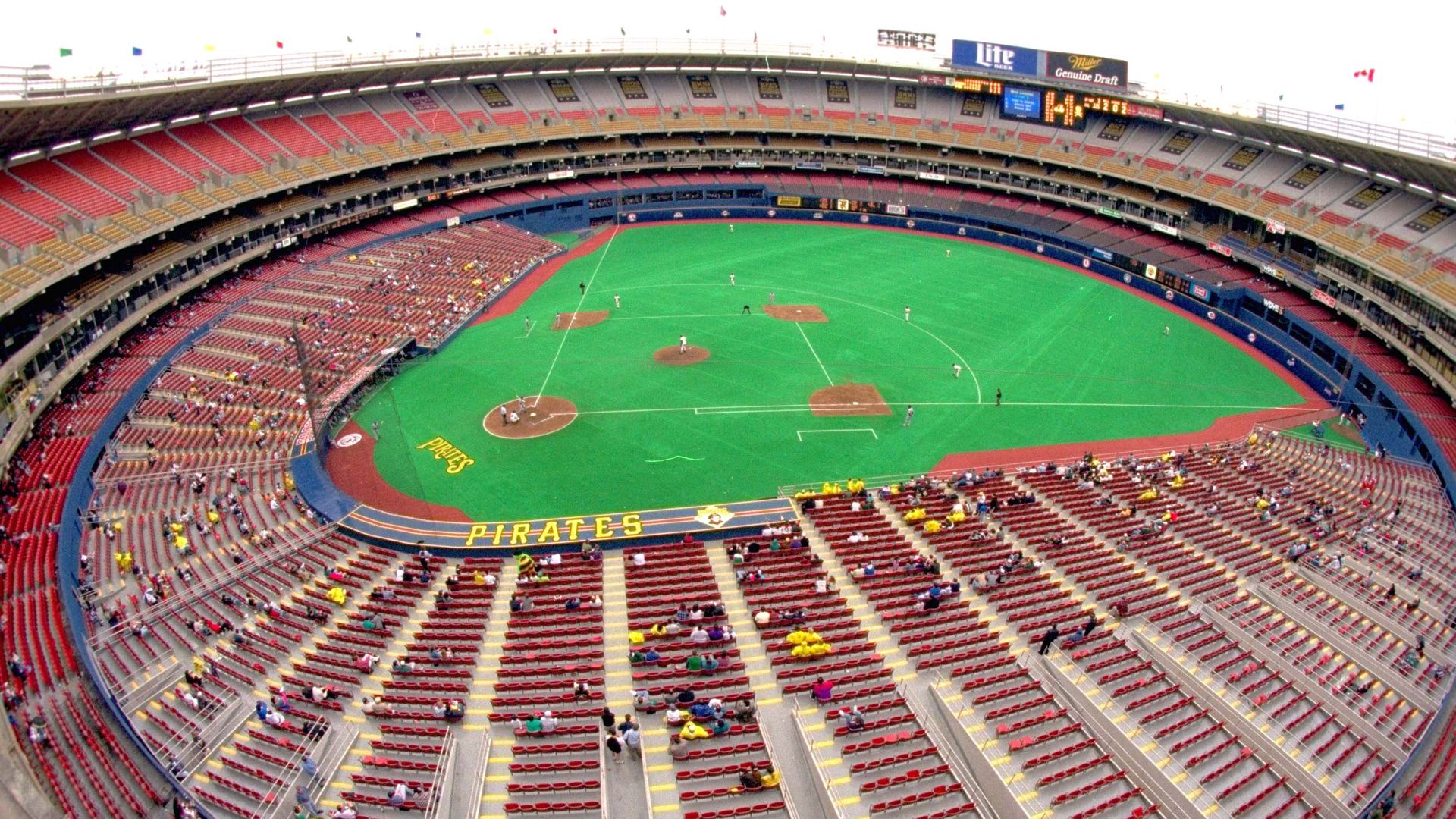 An aerial view of Three Rivers Stadium in Pittsburgh with scattered fans around the ballpark.