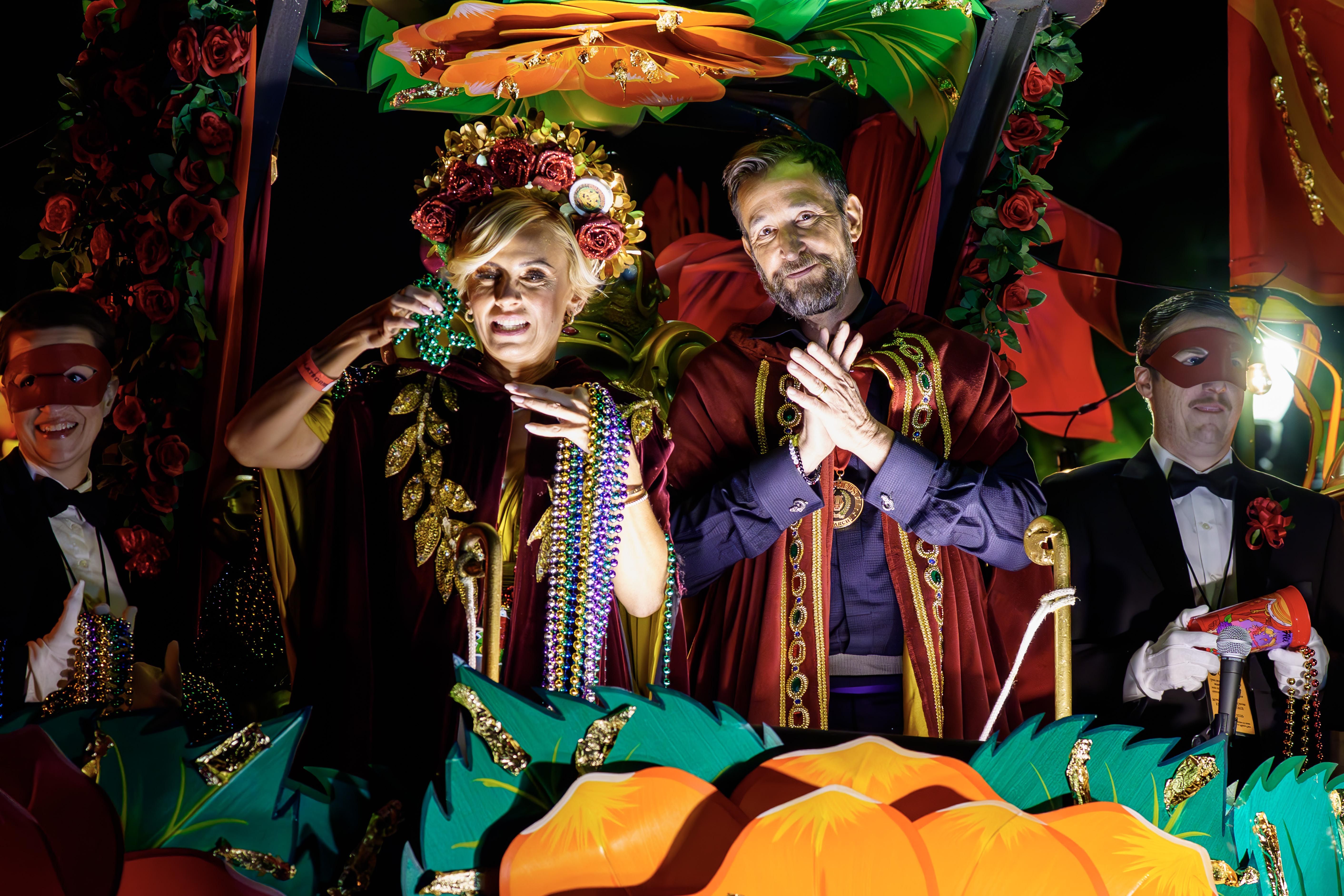 Photo shows Sara Wells and Celebrity Monarch Noah Wyle riding in the Krewe of Orpheus parade during Mardi Gras.
