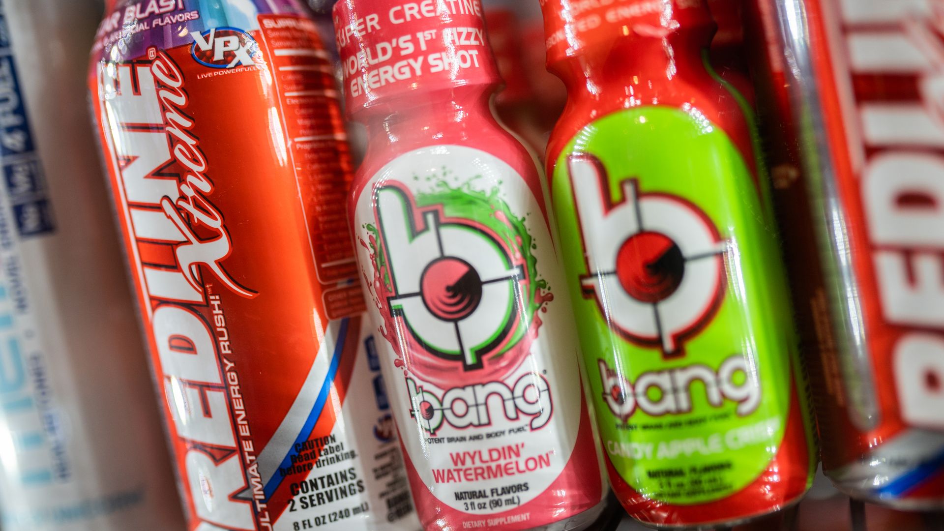 Brightly colored Bang Energy drink bottles sit on a shelf.