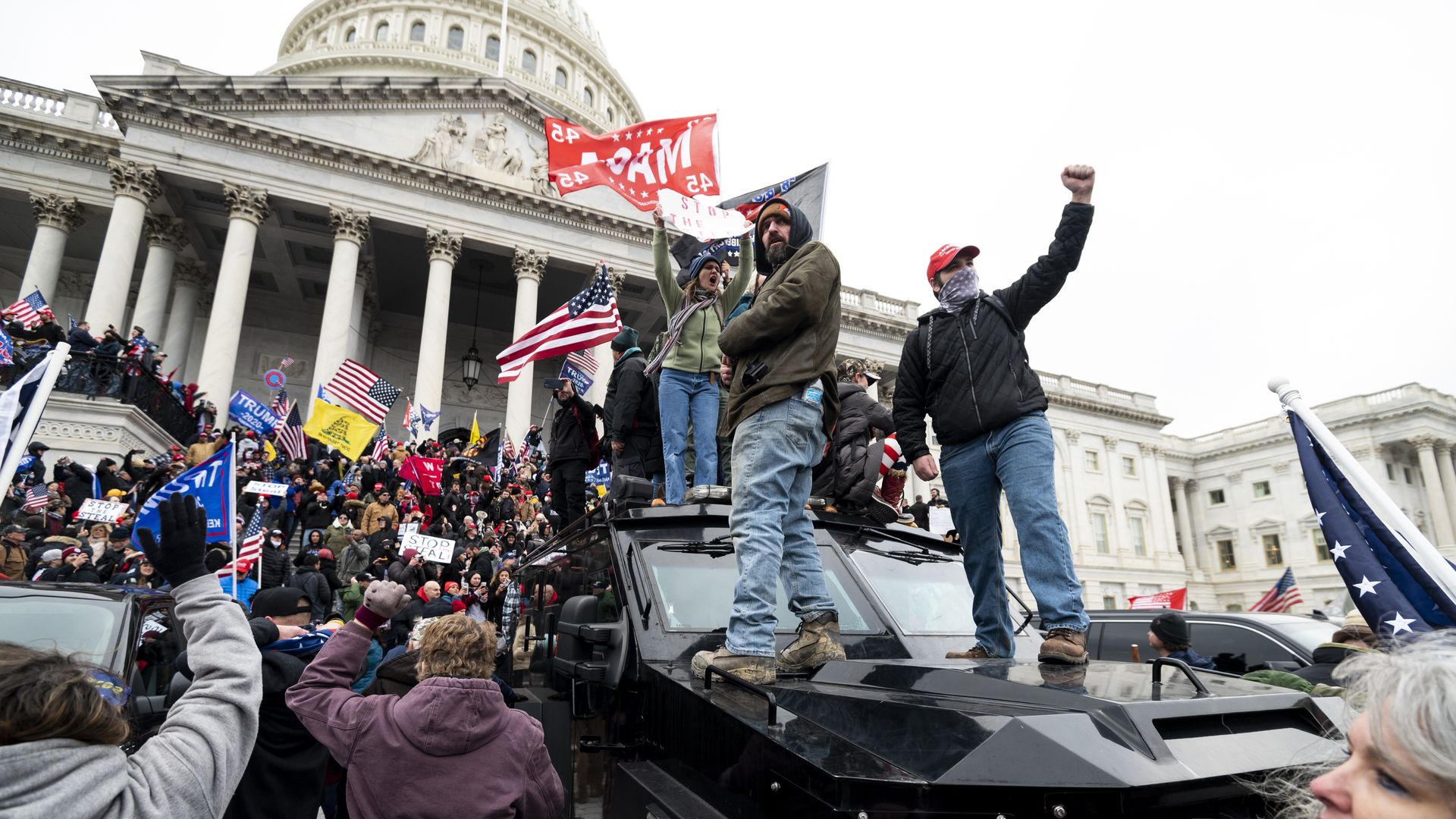 Trump supporters stand on the U.S. Capitol Police armored vehicle 