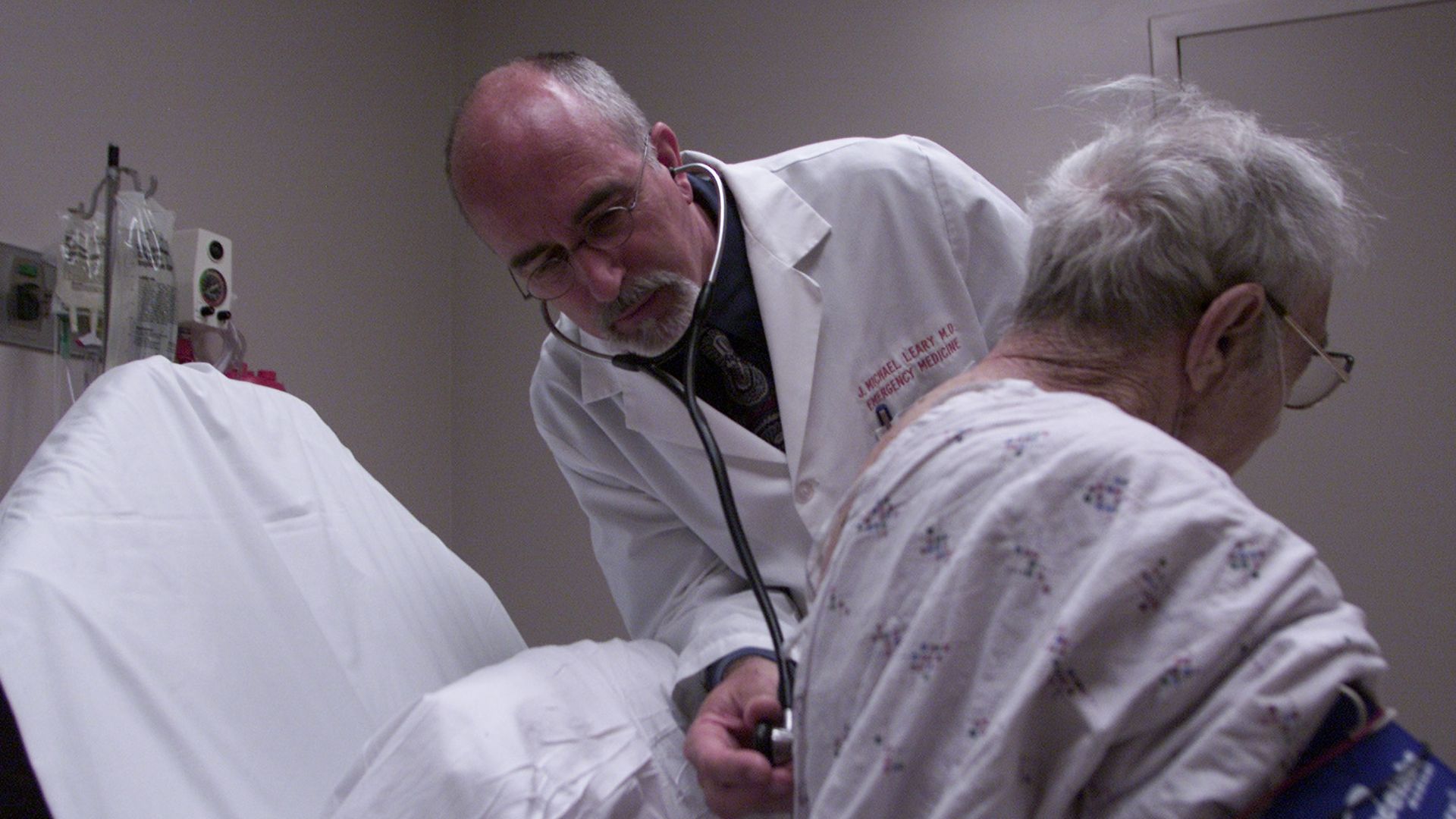 A doctor listens to an elderly patient