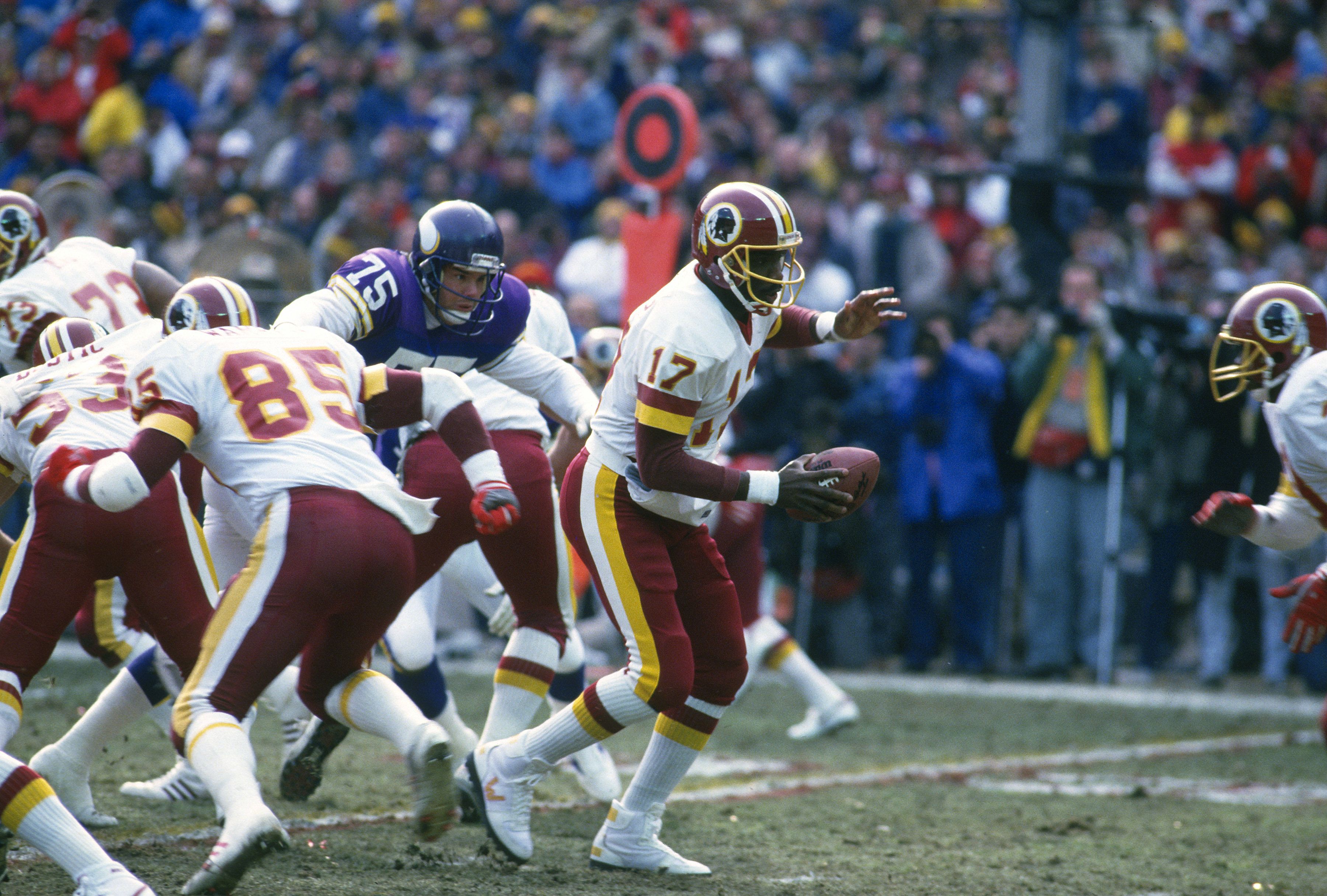 Doug Williams, of QB the Washington Football Team, turns to handoff to a running back against the Minnesota Vikings during the NFC Championship Game January 17, 1988 at RFK Stadium.