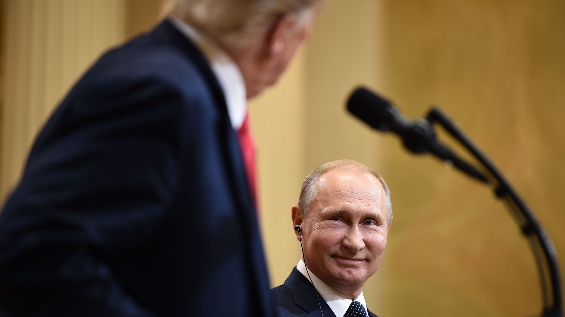 Vladimir Putin smiles at President Trump.