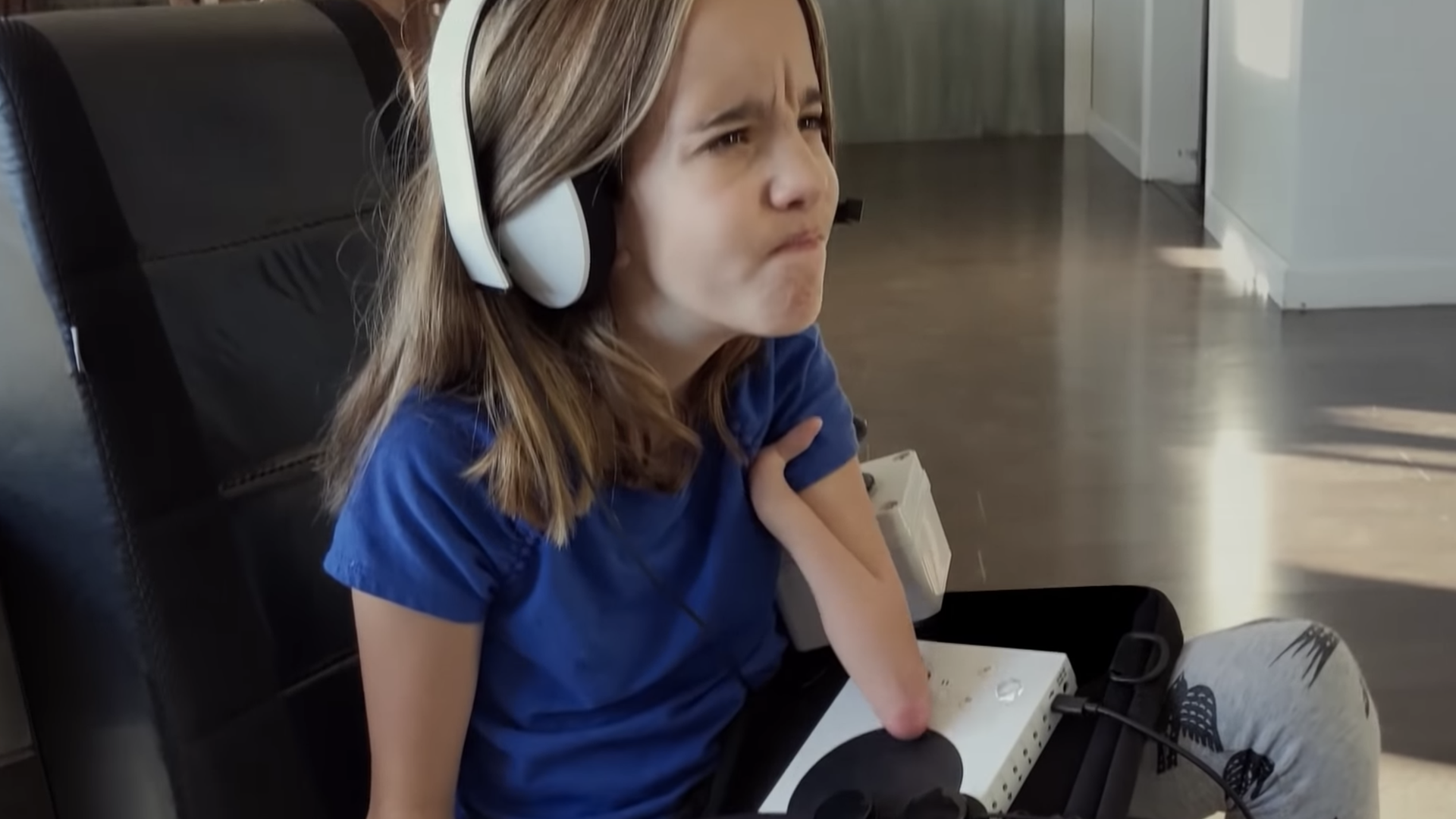 A young girl uses Microsoft's adaptive Xbox controller in a Microsoft ad