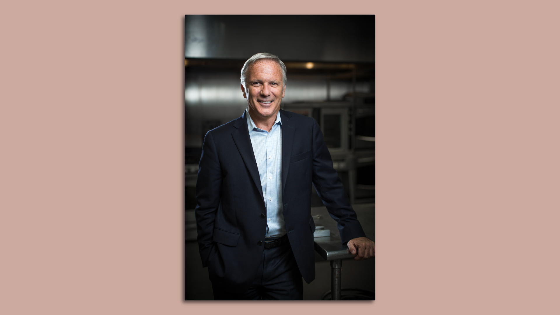 Donatos Pizza CEO Tom Krouse stands in a kitchen. 