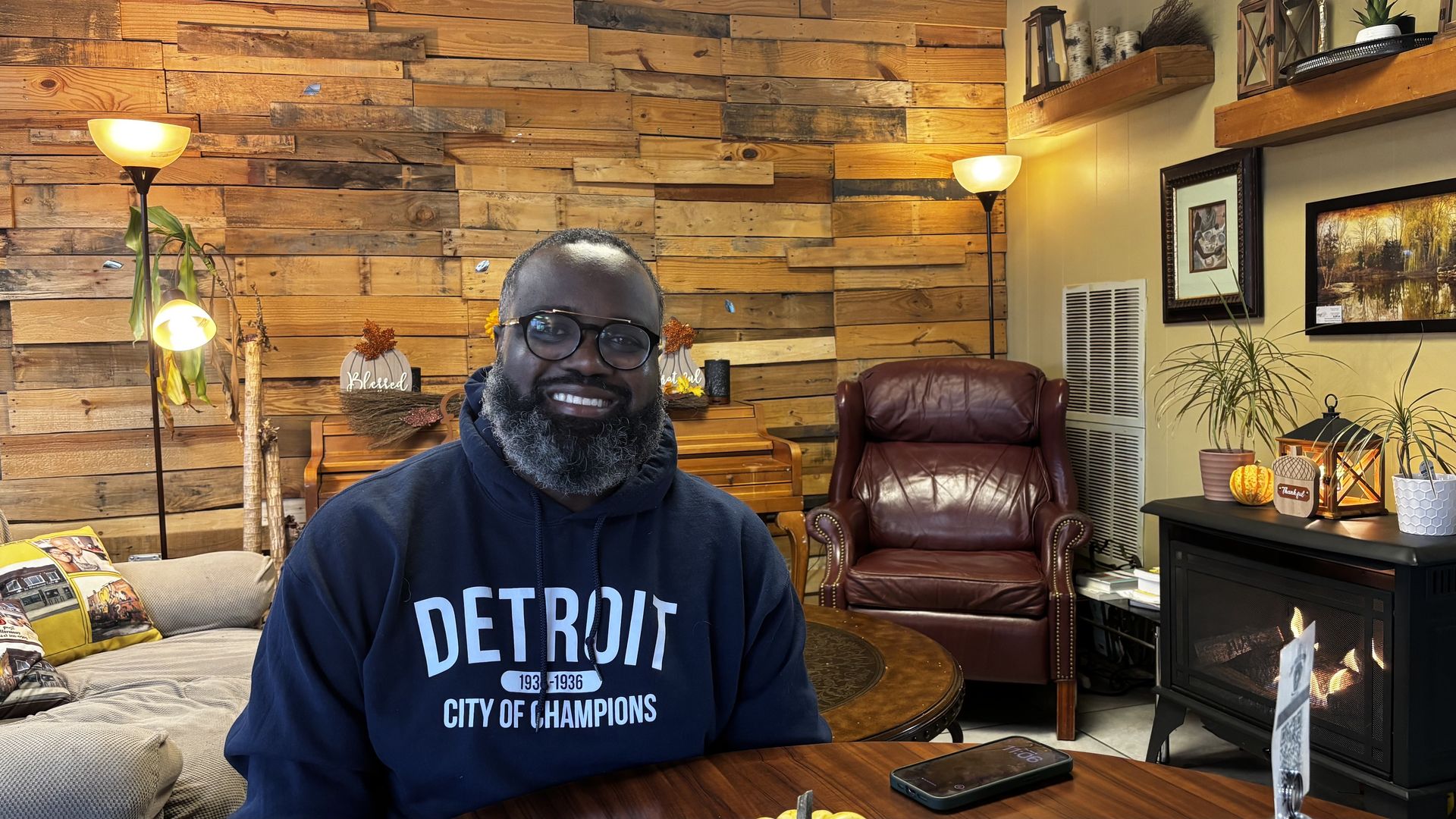 Denzel McCampbell sits at a table inside Detroit's In Harmony Café.