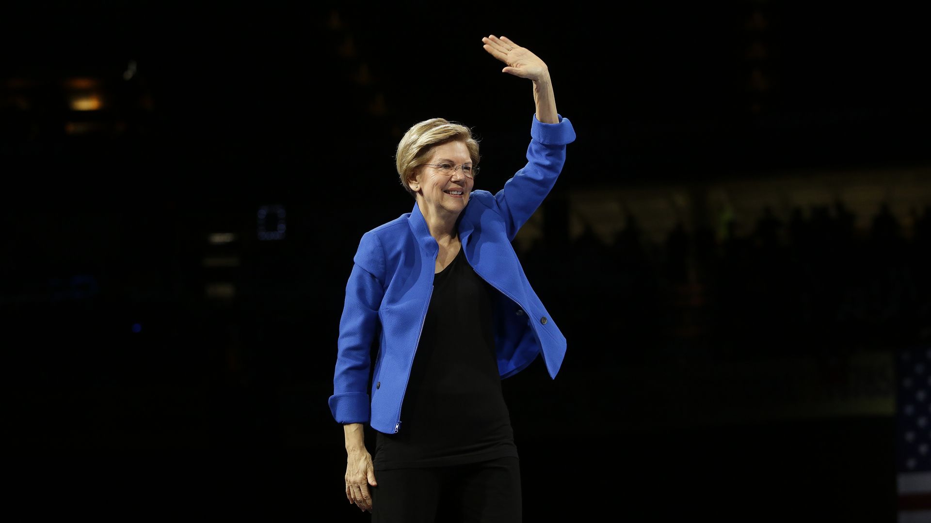 Elizabeth Warren waves at a crowd.