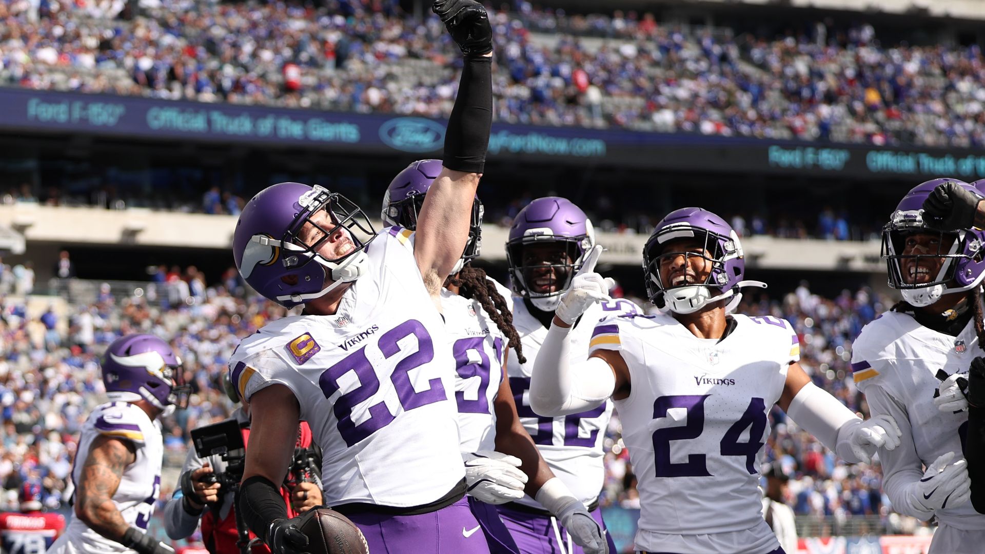 Harrison Smith celebrates an interception with teammates surrounding him 