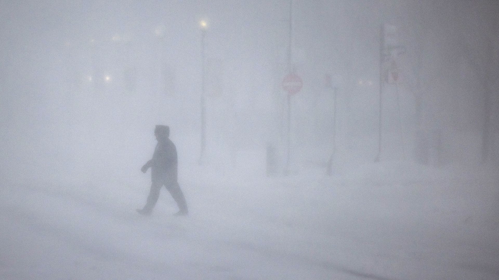 People walk through whiteout conditions on February 23, 2026 in Boston, Massachusetts. The northeast U.S. was hit by an intense nor'easter with blizzard conditions, heavy snow, and strong winds.