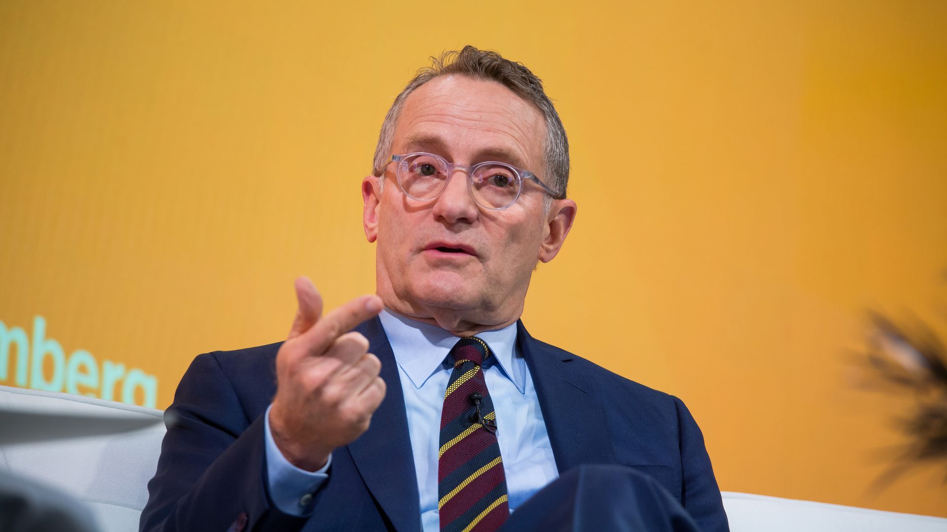 Howard Marks speaks while sitting in a chair.