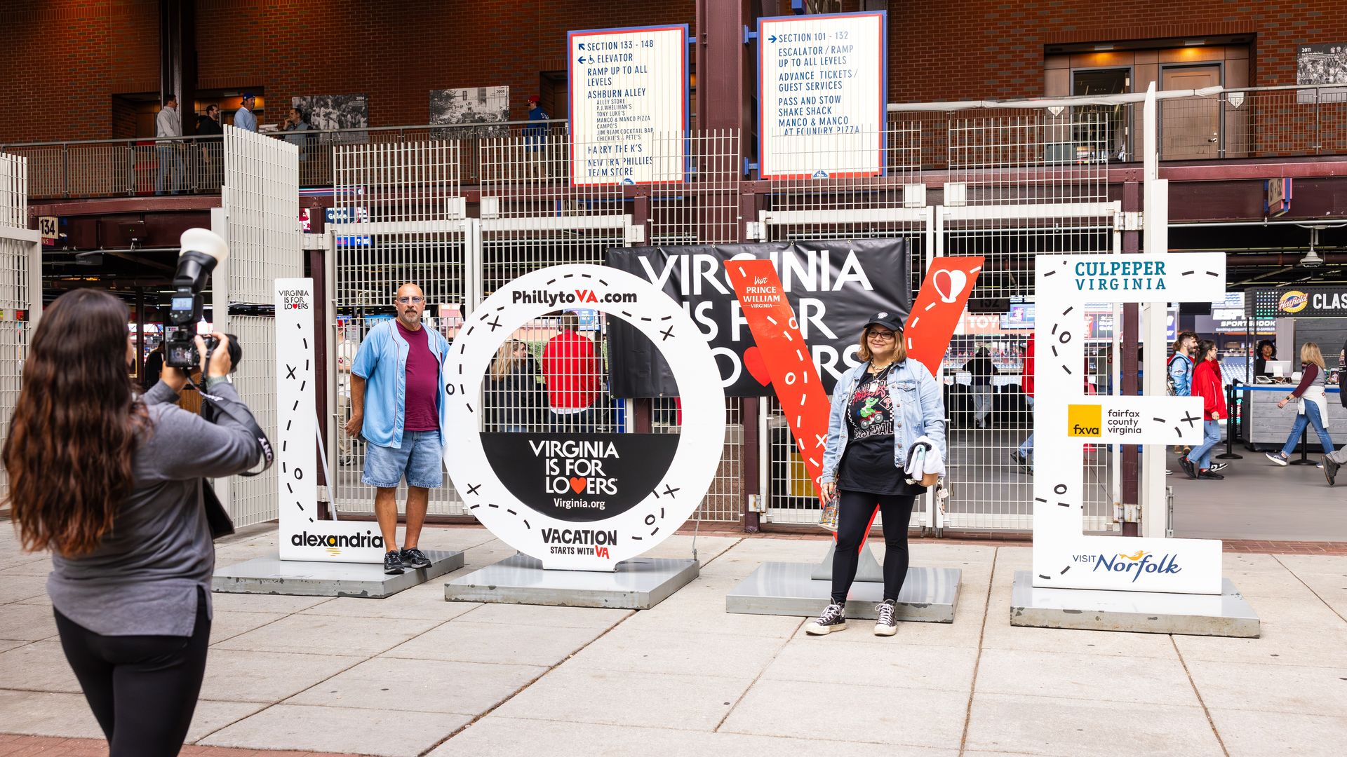 A bunch of people standing in front of a LOVE sign in Philly 