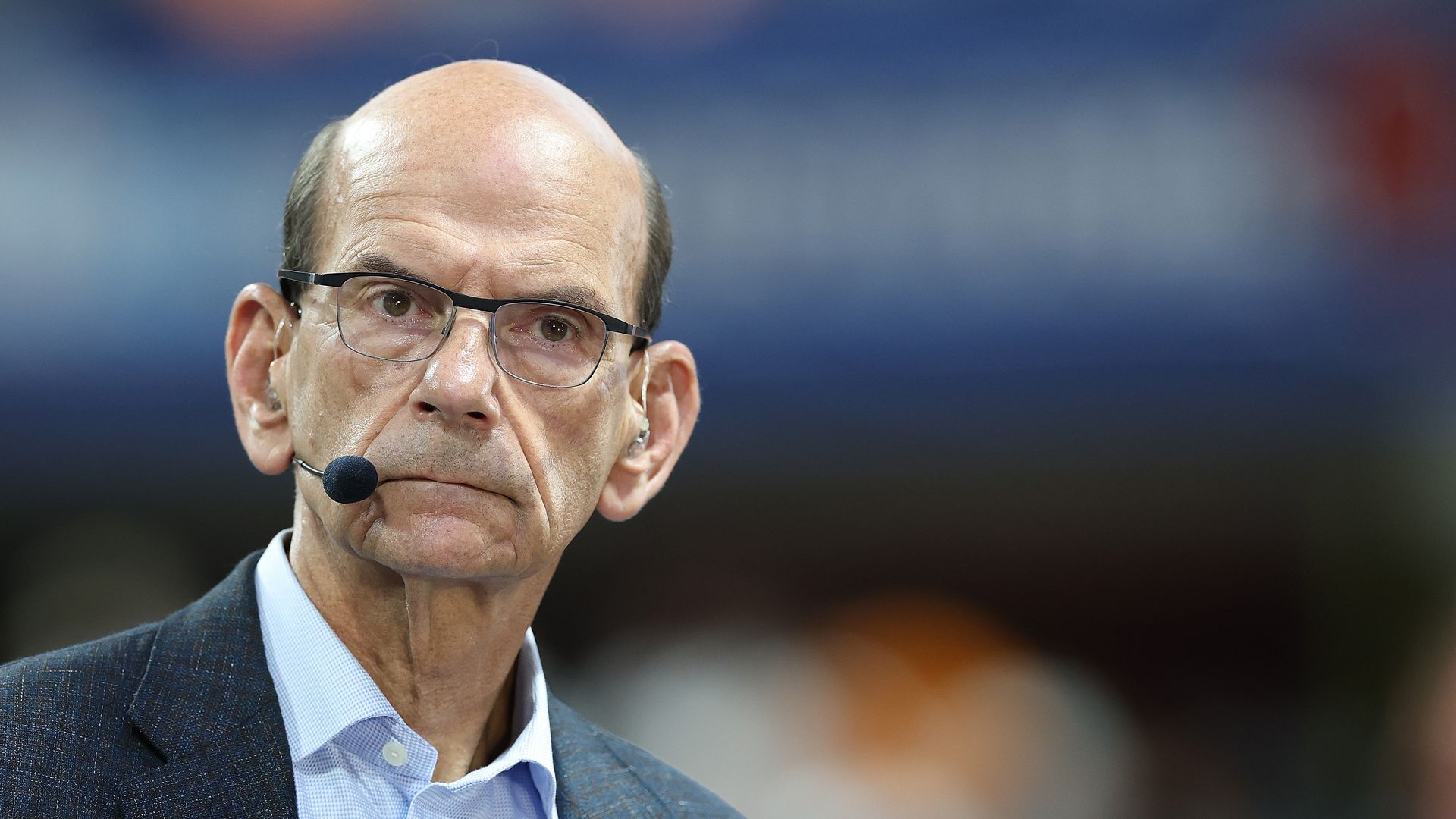 Paul Finebaum is shown looking toward the camera in front of a blurred background.