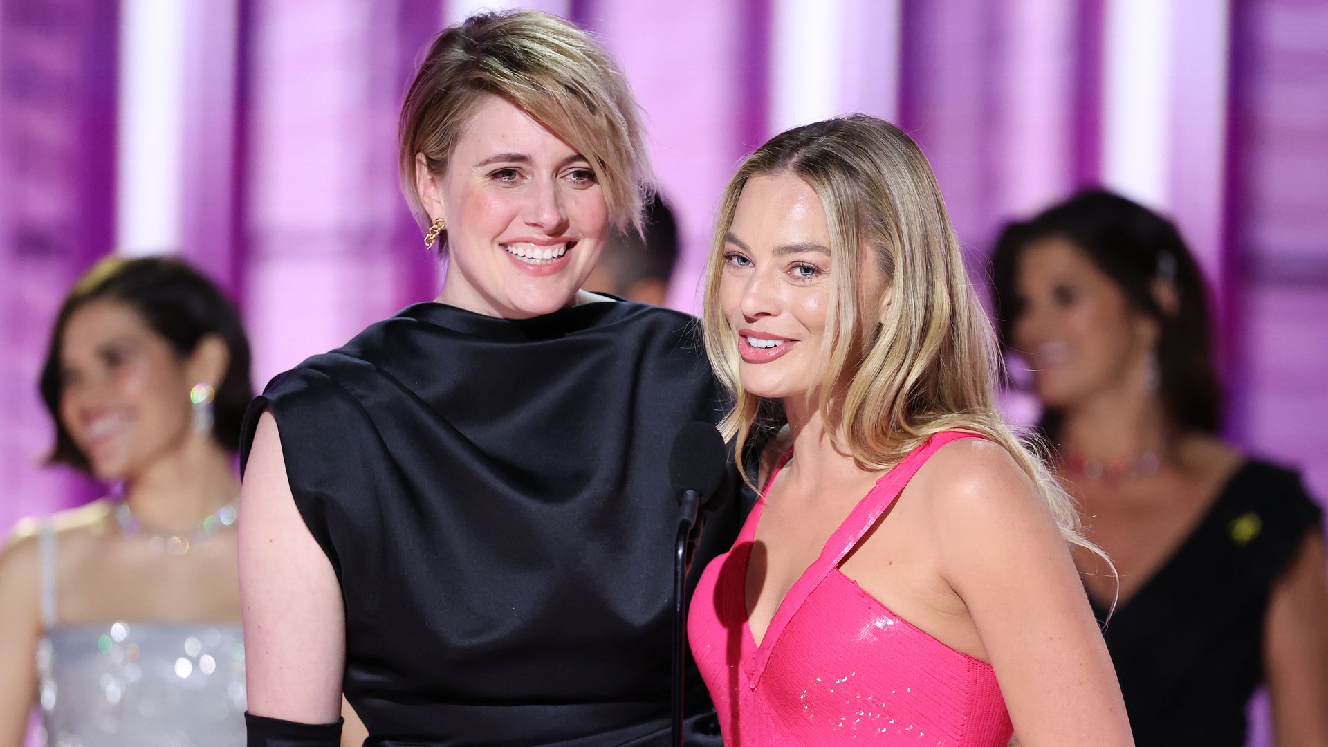 Greta Gerwig and Margot Robbie accepts the award for Cinematic and Box Office Achievement for "Barbie" at the 81st Golden Globe Awards held at the Beverly Hilton Hotel on January 7, 2024 in Beverly Hills, California.