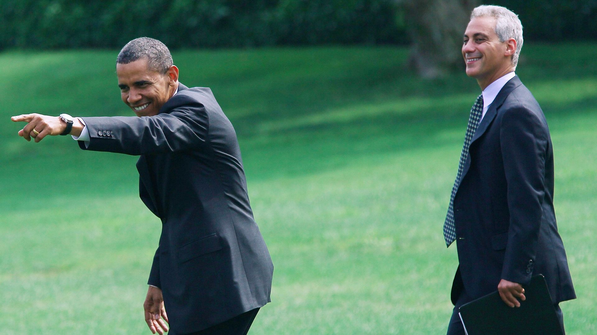 Former White House Chief of Staff Rahm Emanuel walks behind President Obama in 2010.