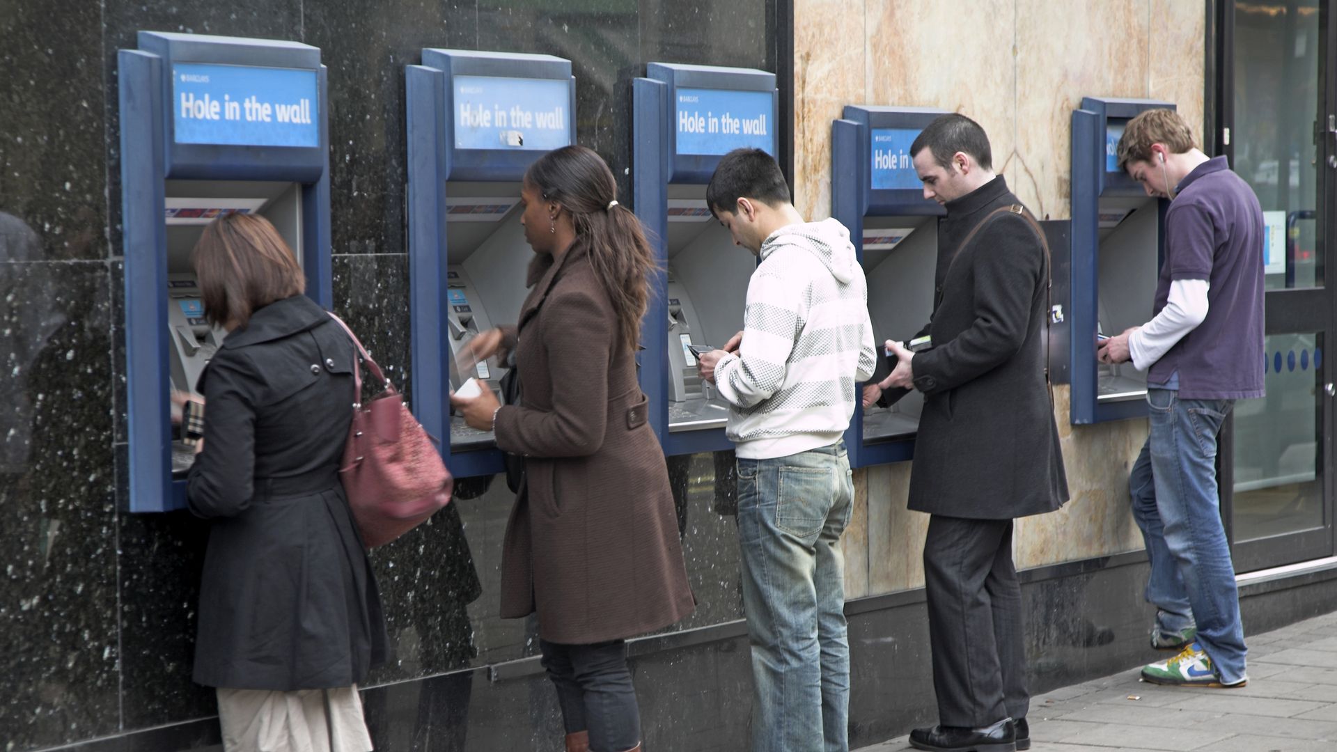 People line up at ATM machines