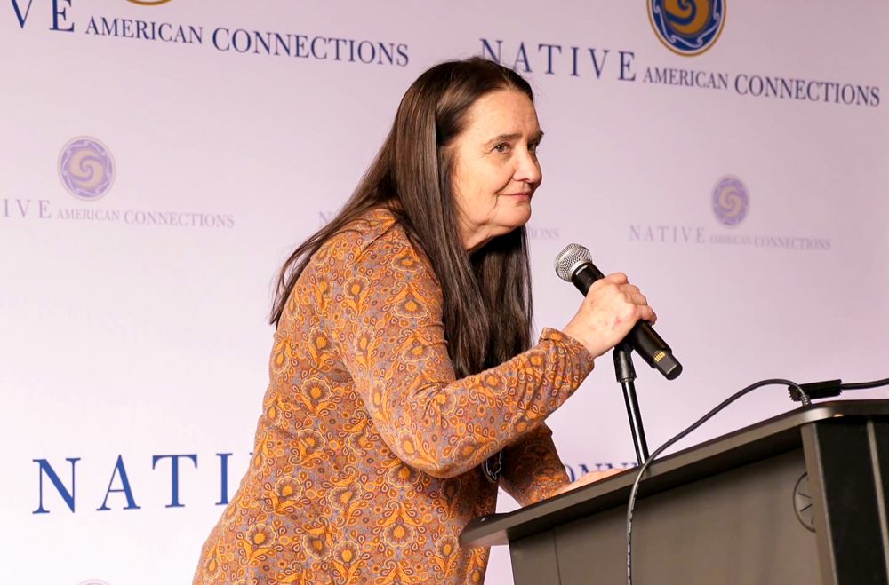 A woman speaking at a podium.