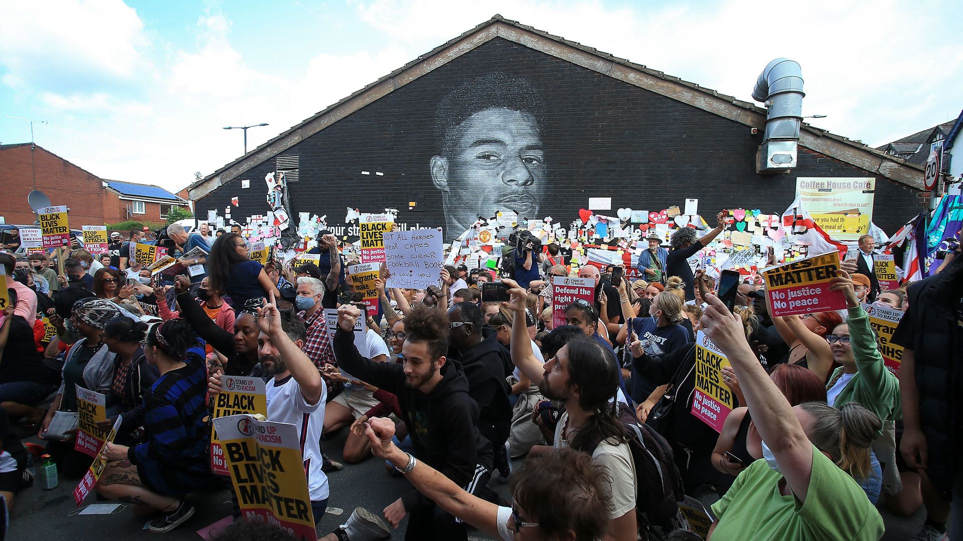 Anti-racism protestors demonstrate by a mural of England forward Marcus Rashford.