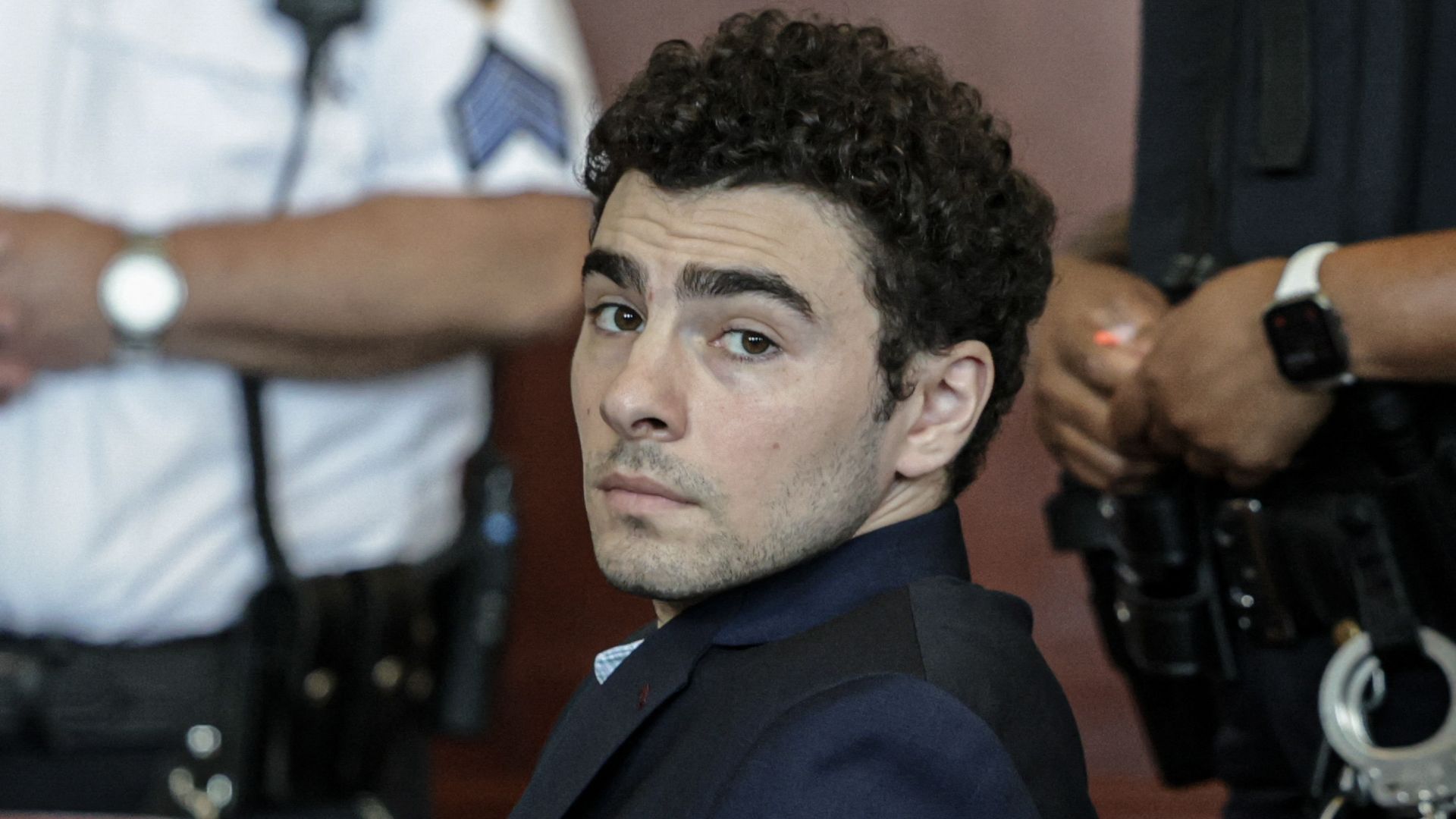 Luigi Mangione, accused of the murder of UnitedHealthcare CEO Brian Thompson, attends a court hearing in New York, on May 18, 2026. (Photo by Jeenah Moon / POOL / AFP via Getty Images)

