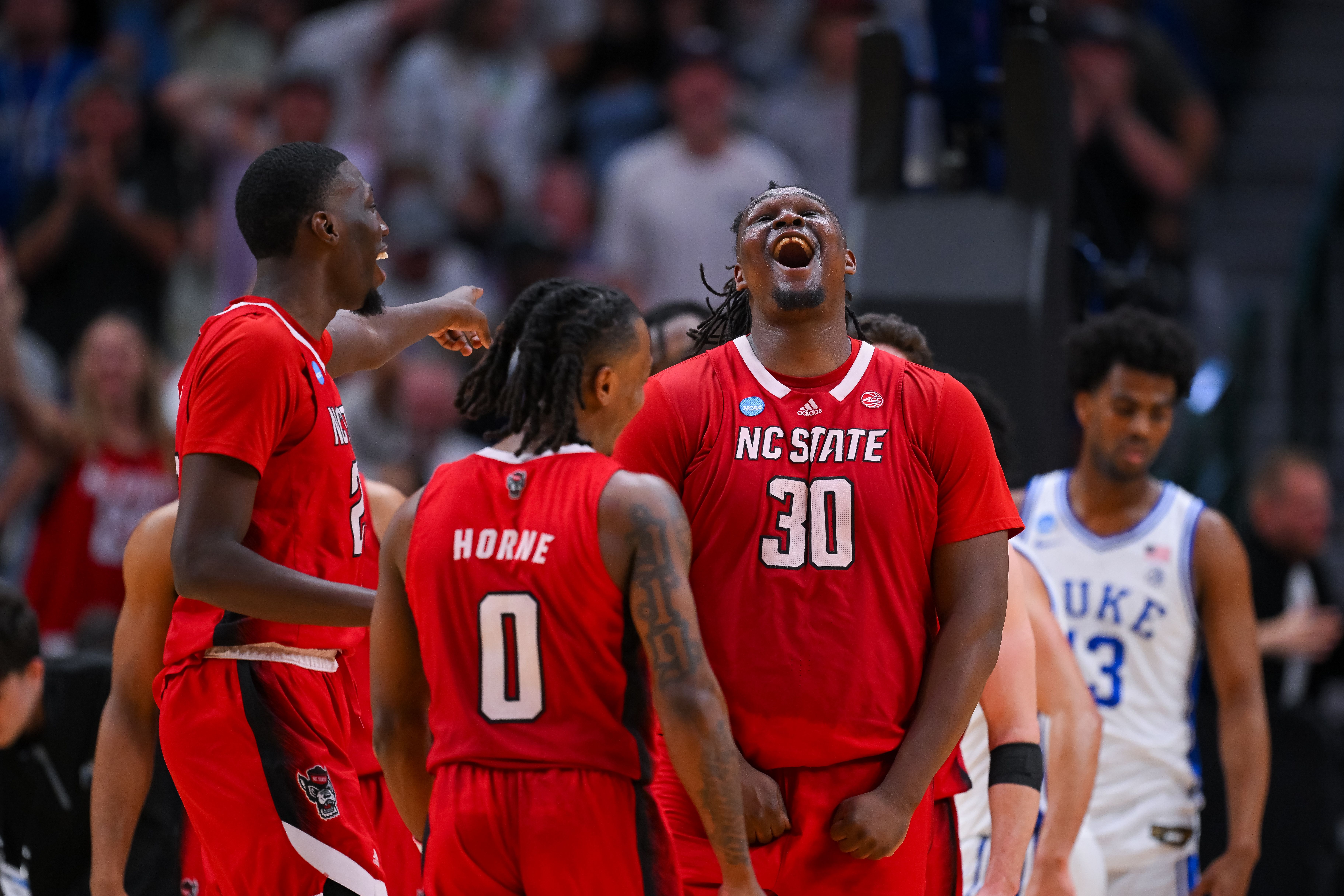DJ Burns celebrates with his NC State teammates. Photo: Andy Hancock/NCAA Photos/NCAA Photos via Getty Images
