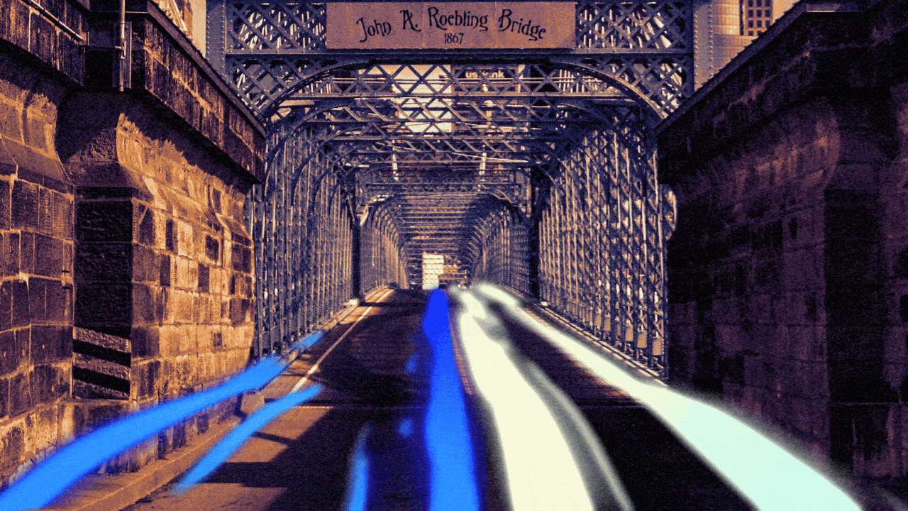 Animated illustration of the Roebling Bridge, with streaks of blue and white lights from car headlights and taillights flowing toward and away from the reader, forming an abstracted Axios A logo.