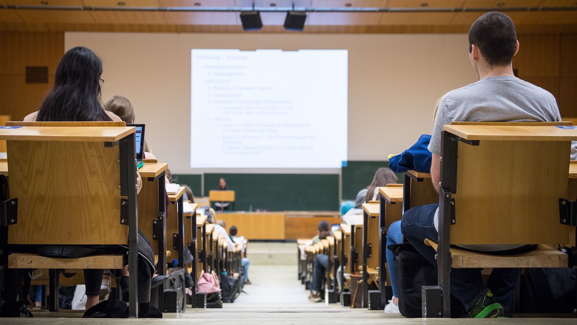 A photo of a full lecture hall from the back