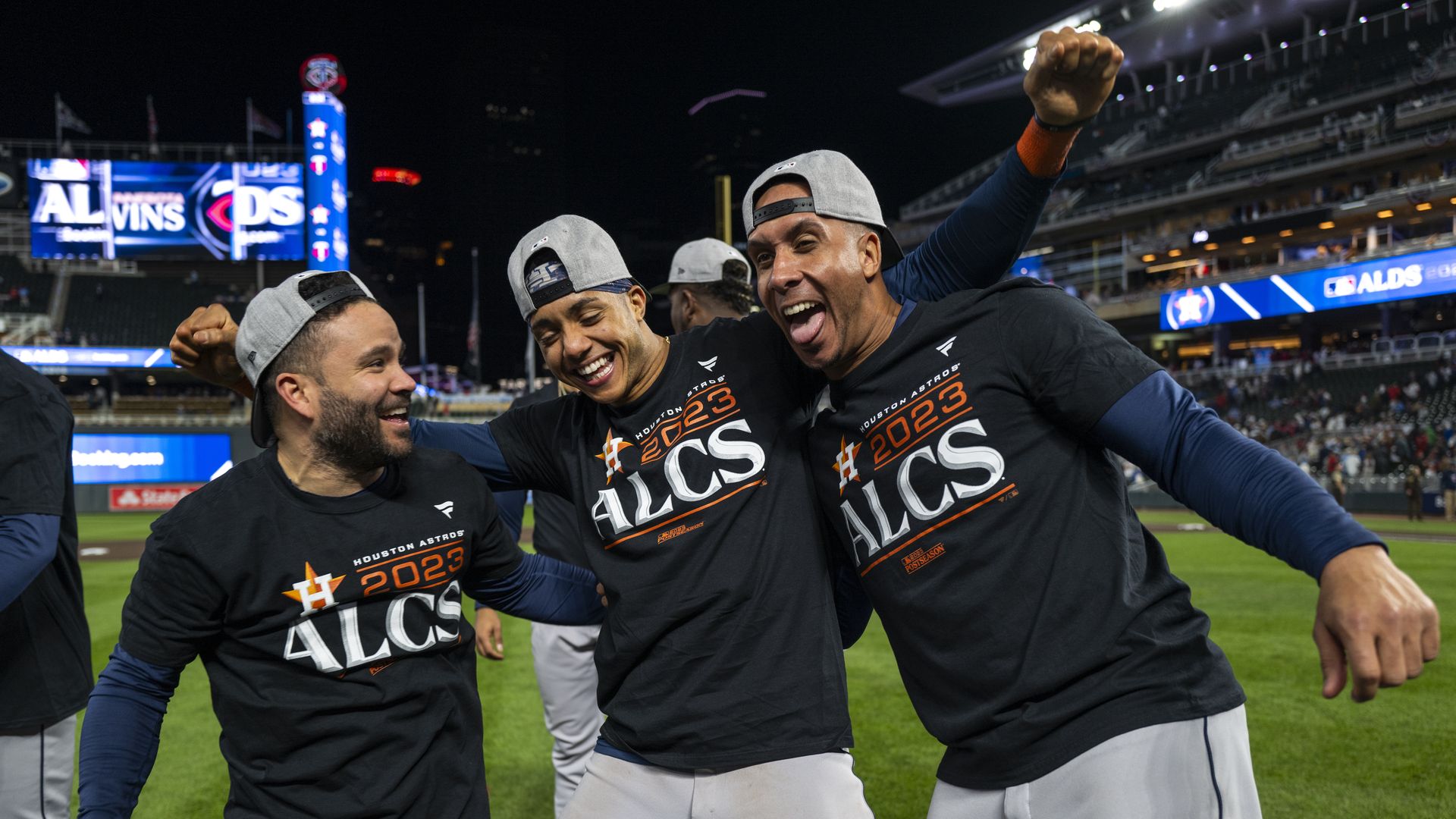 Astros players Jose Altuve, Jeremy Peña and Michael Brantley embrace each other after winning the 2023 ALDS
