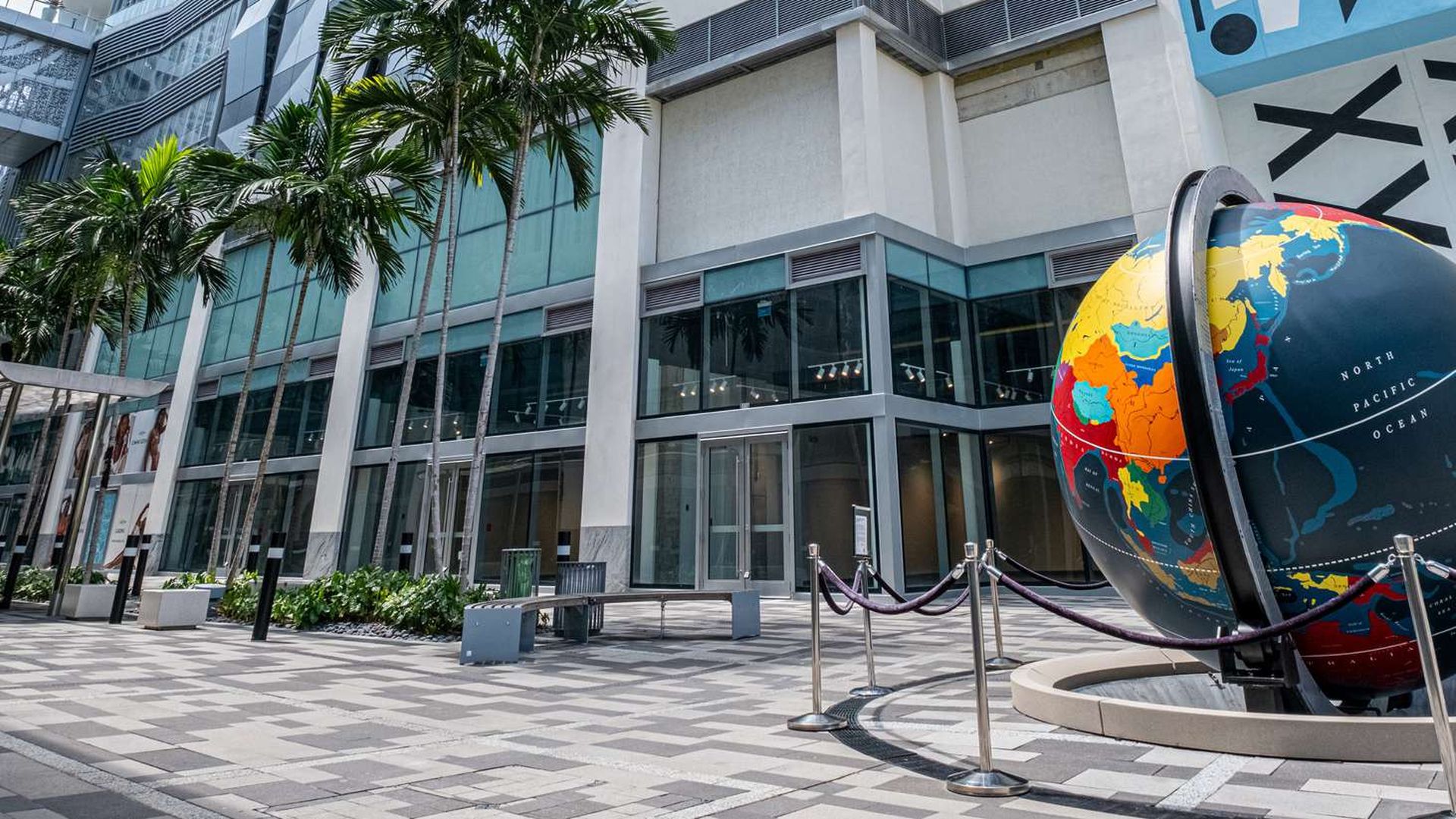 The corner of a building with a globe structure.