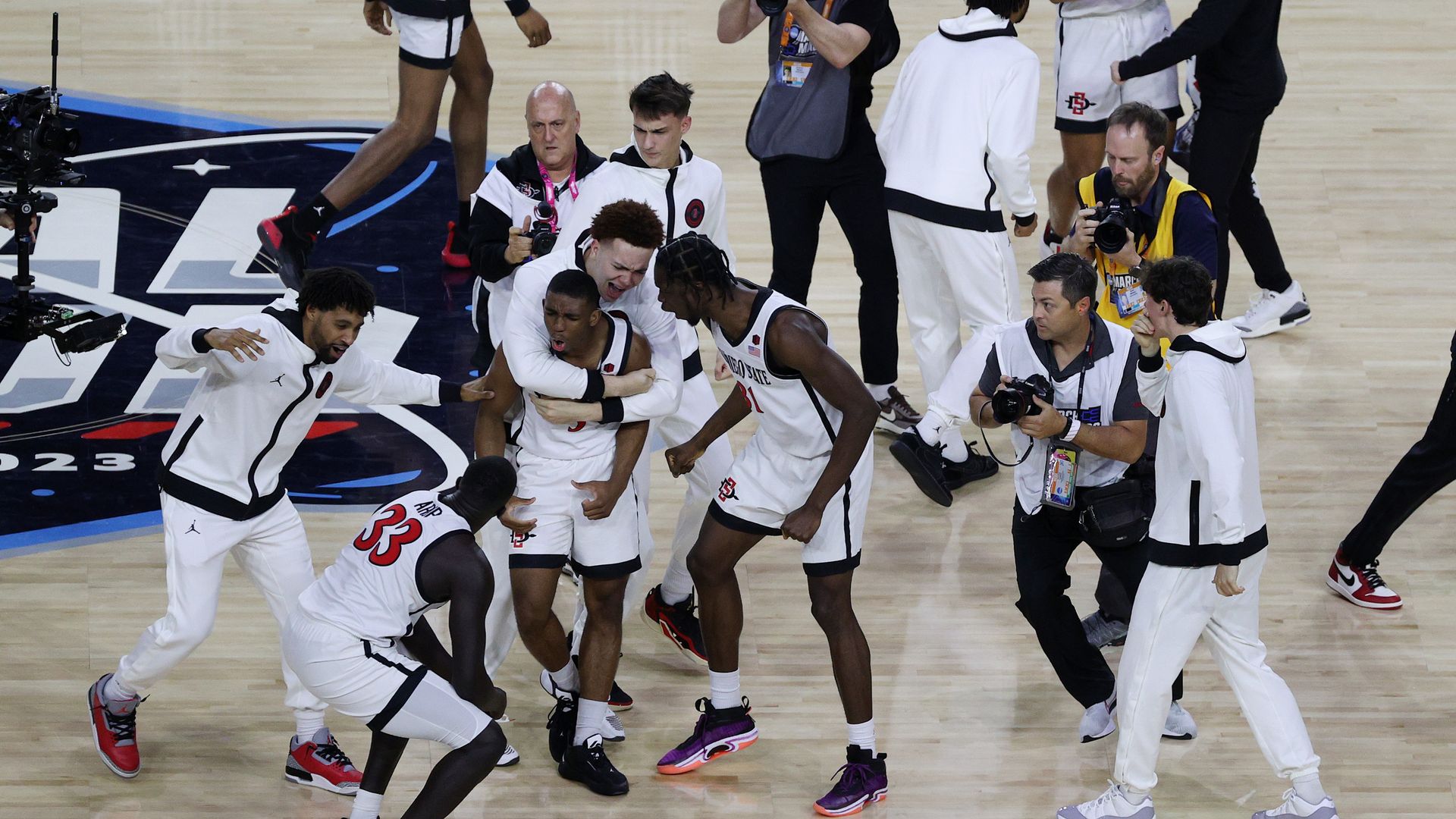 Lamont Butler and Aztecs teammates celebrate after advancing to the 2023 national championship