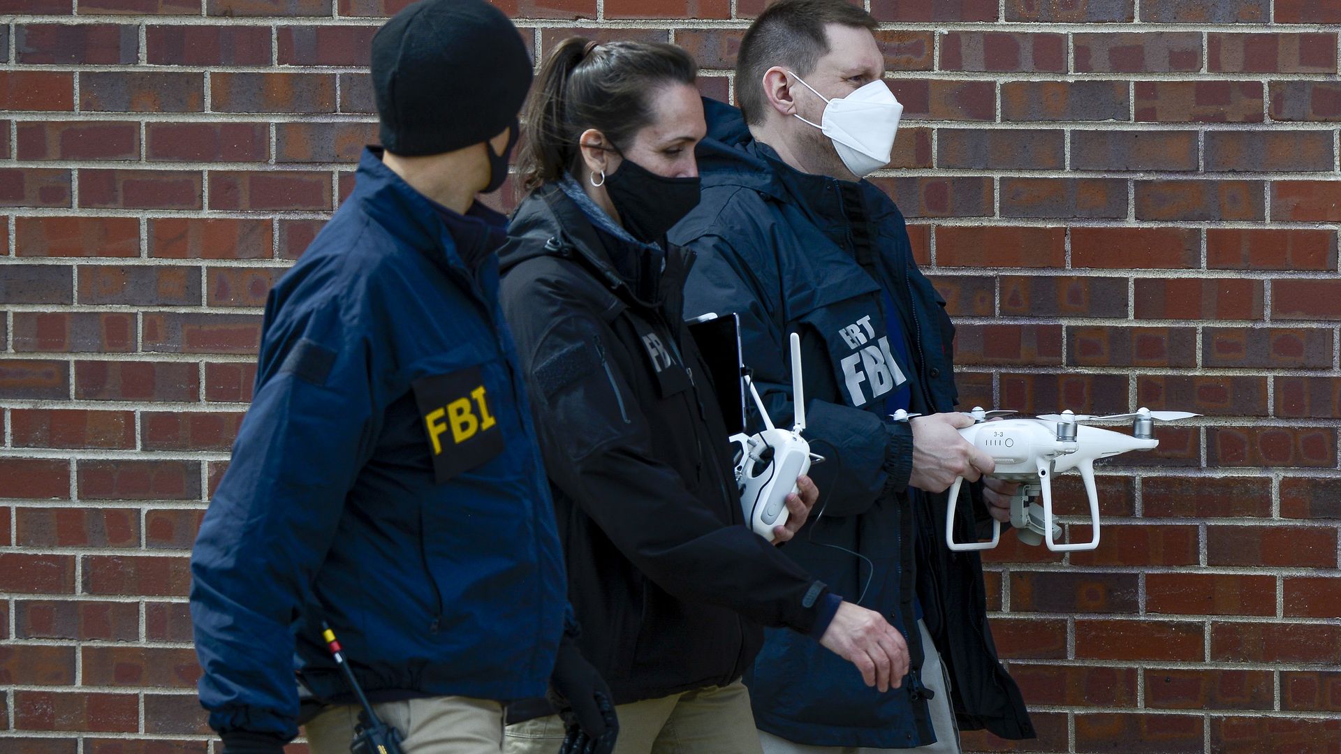 FBI agents carrying a drone inn Boulder, Colorado, on March 25.