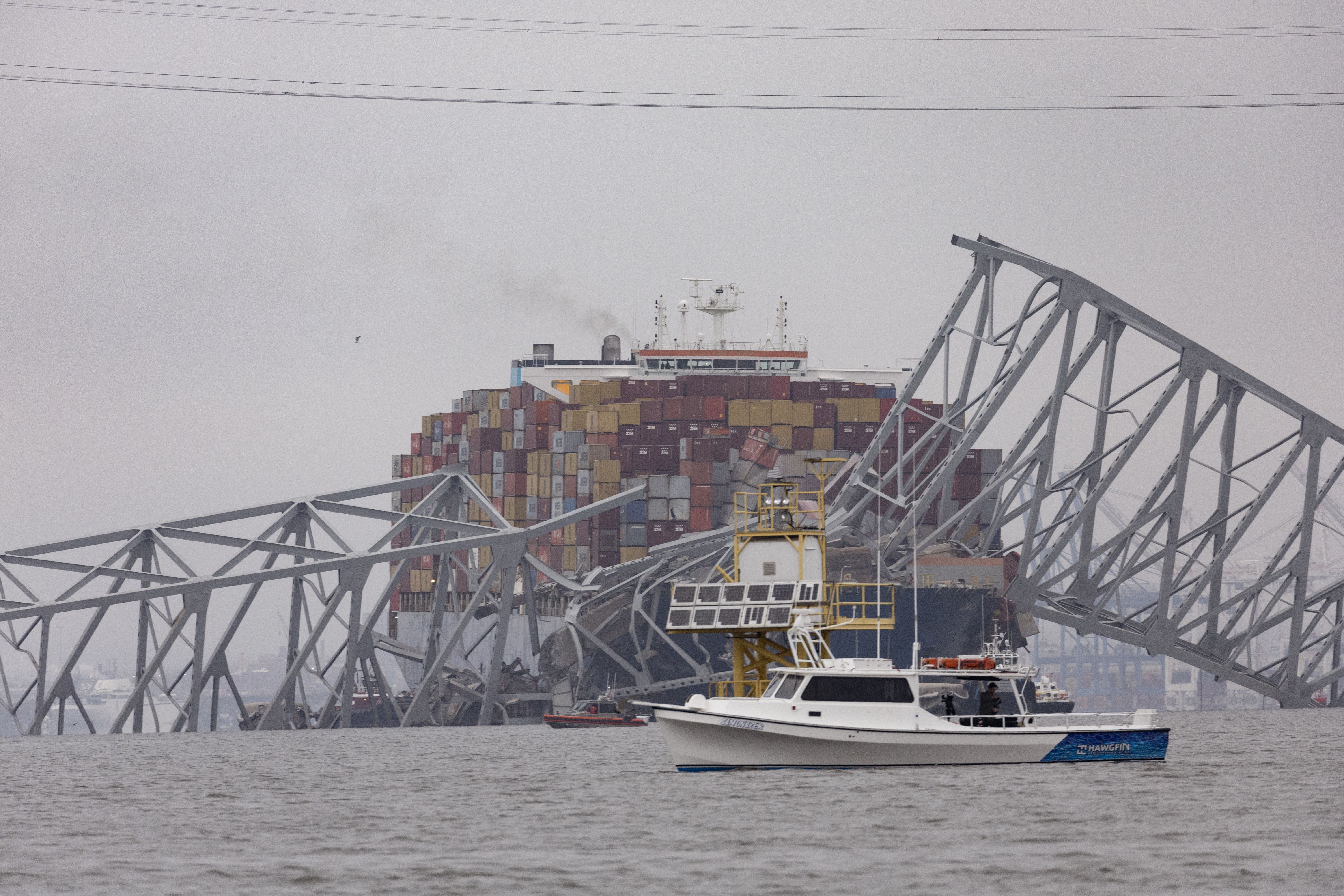 BALTIMORE, MARYLAND - MARCH 27: Workers continue to investigate and search for victims after the cargo ship Dali collided with the Francis Scott Key Bridge causing it to collapse yesterday, on March 27, 2024 in Baltimore, Maryland. Two survivors were pulled from the Patapsco River and six missing people are presumed dead after the Coast Guard called off rescue efforts. A work crew was fixing potholes on the bridge, which is used by roughly 30,000 people each day, when the ship struck at around 1:30am on Tuesday morning. The accident has temporarily closed the Port of Baltimore, one of the largest and busiest on the East Coast of the U.S. (Photo by Scott Olson/Getty Images)