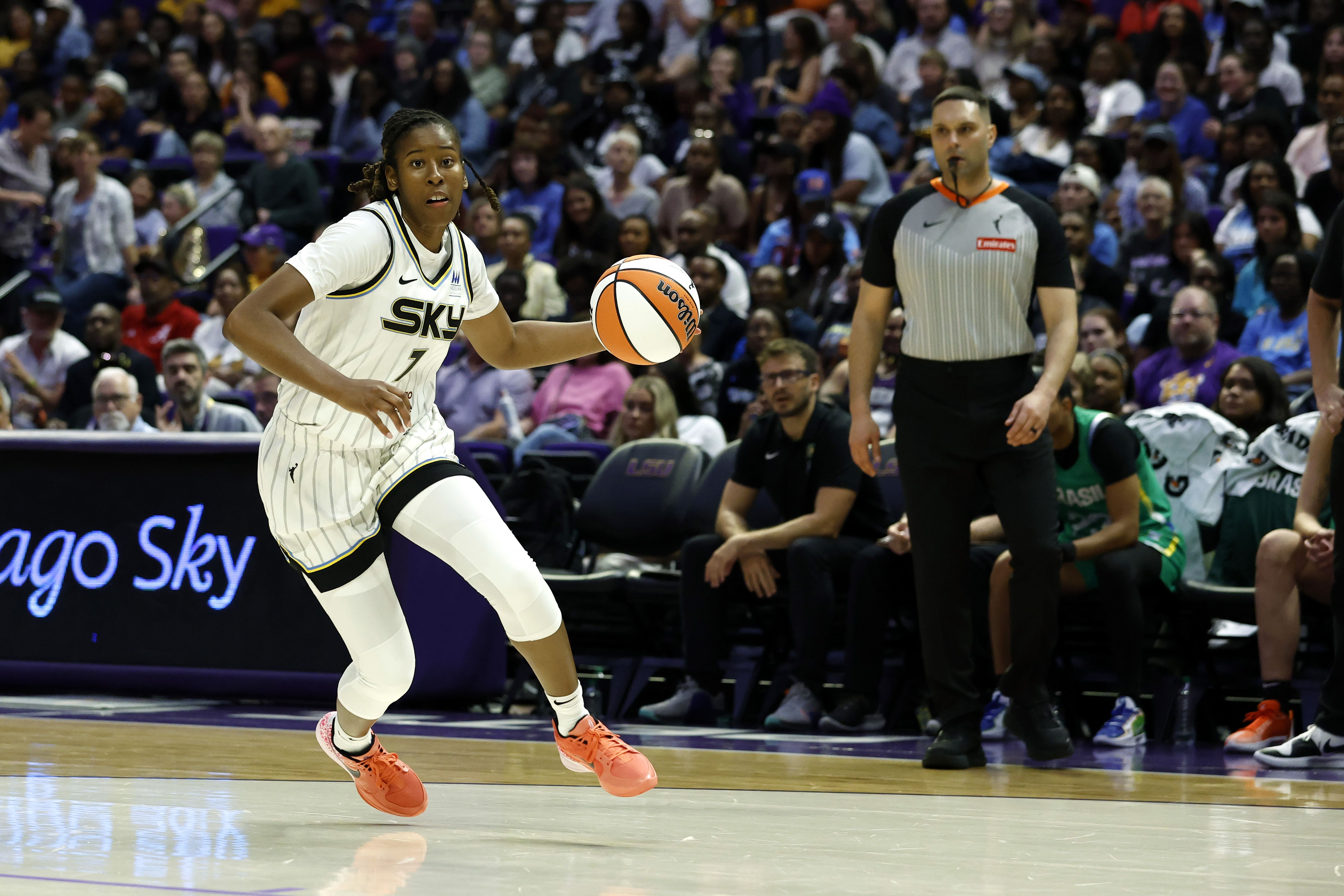 Photo of a basketball player dribbling a basketball during a game. 