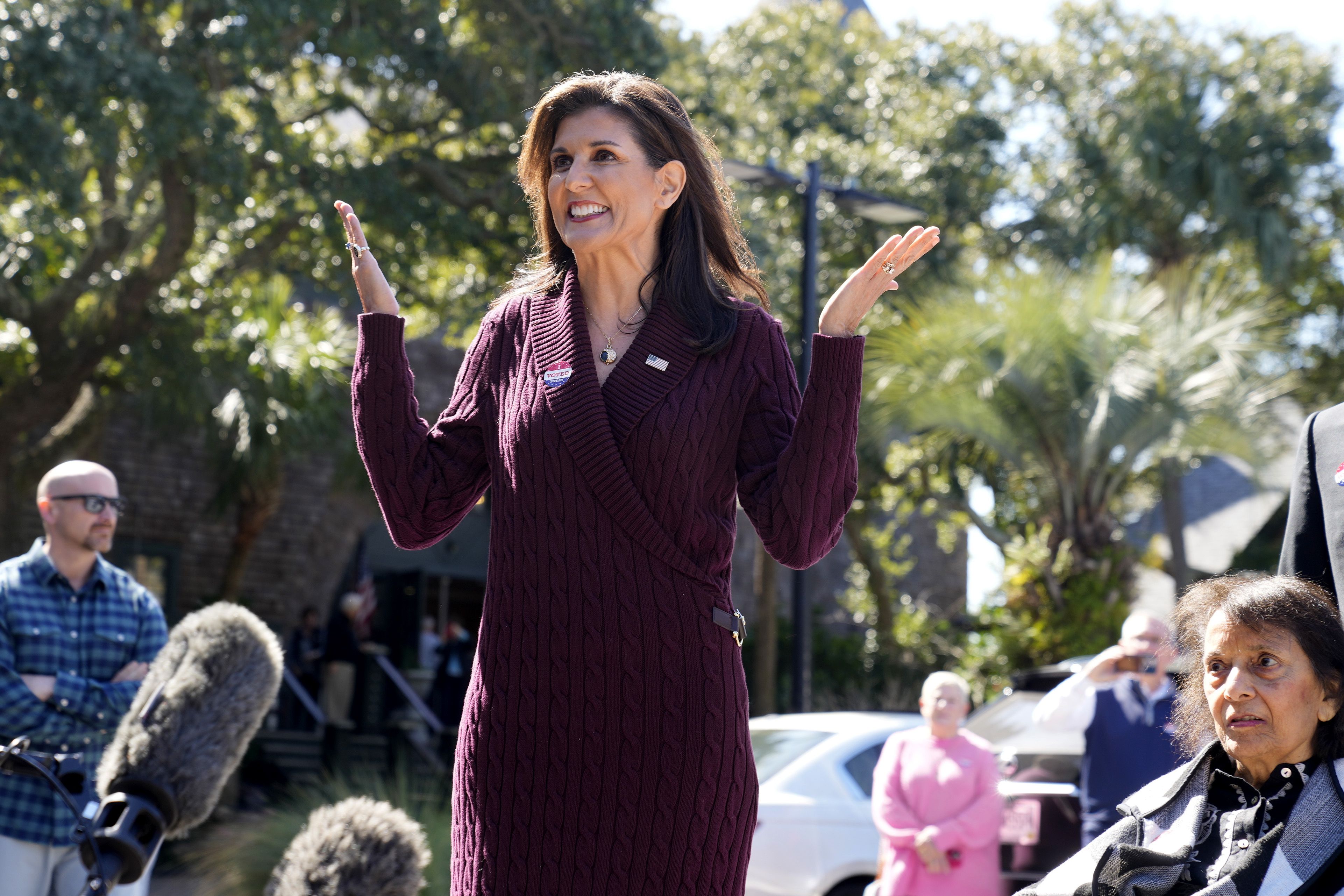 Republican presidential candidate former United Nations Ambassador Nikki Haley gestures as she speaks with reporters after casting her vote in South Carolina's Republican presidential primary on Saturday, Feb. 24, 2024, on Kiawah Island, S.C. Pictured at right is Haley's mother, Raj Randhawa. (AP Photo/Meg Kinnard)