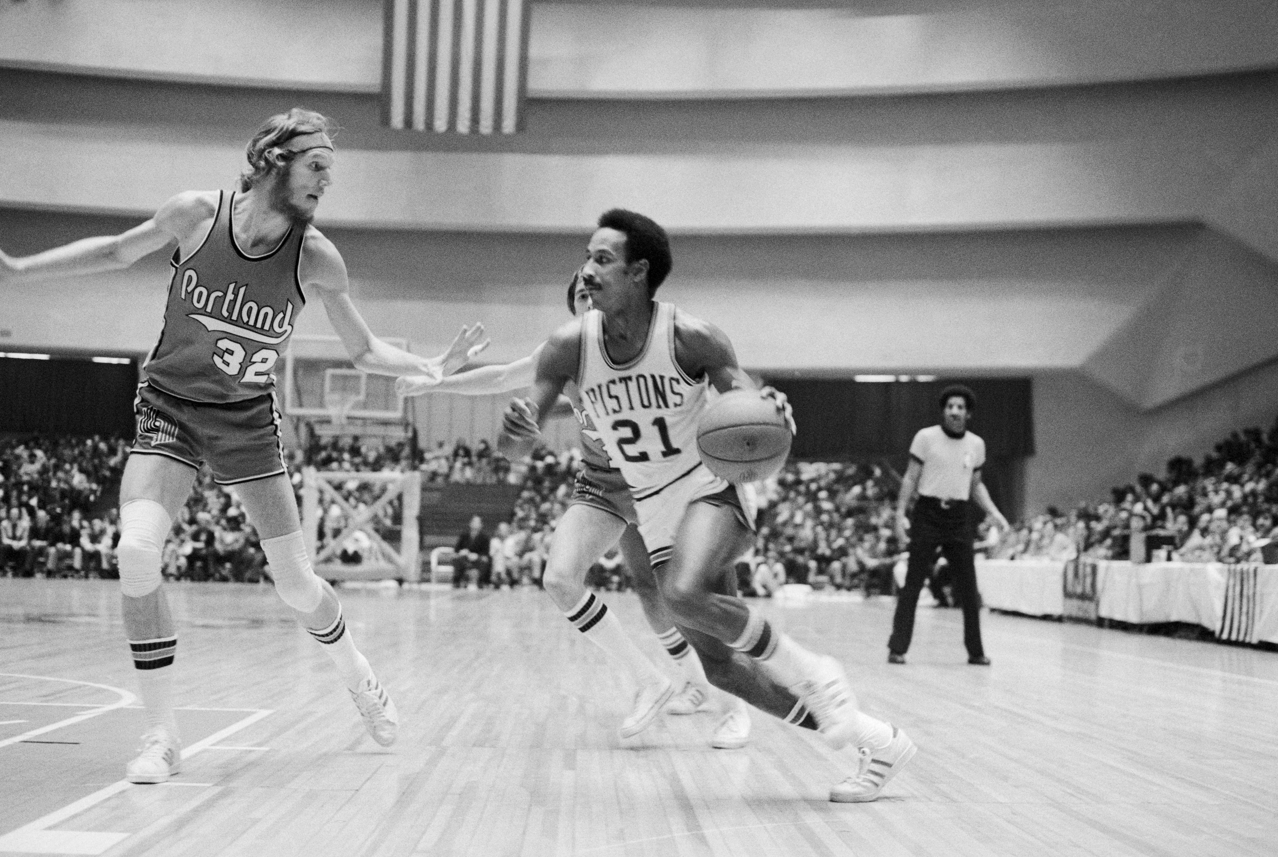 Detroit: Pistons' Dave Bing (21) drives past Trail Blazers' Bill Walton (32), on his way to an easy basket during the first half of the Detroit-Portland game on January 22nd. Pistons won 96-94.