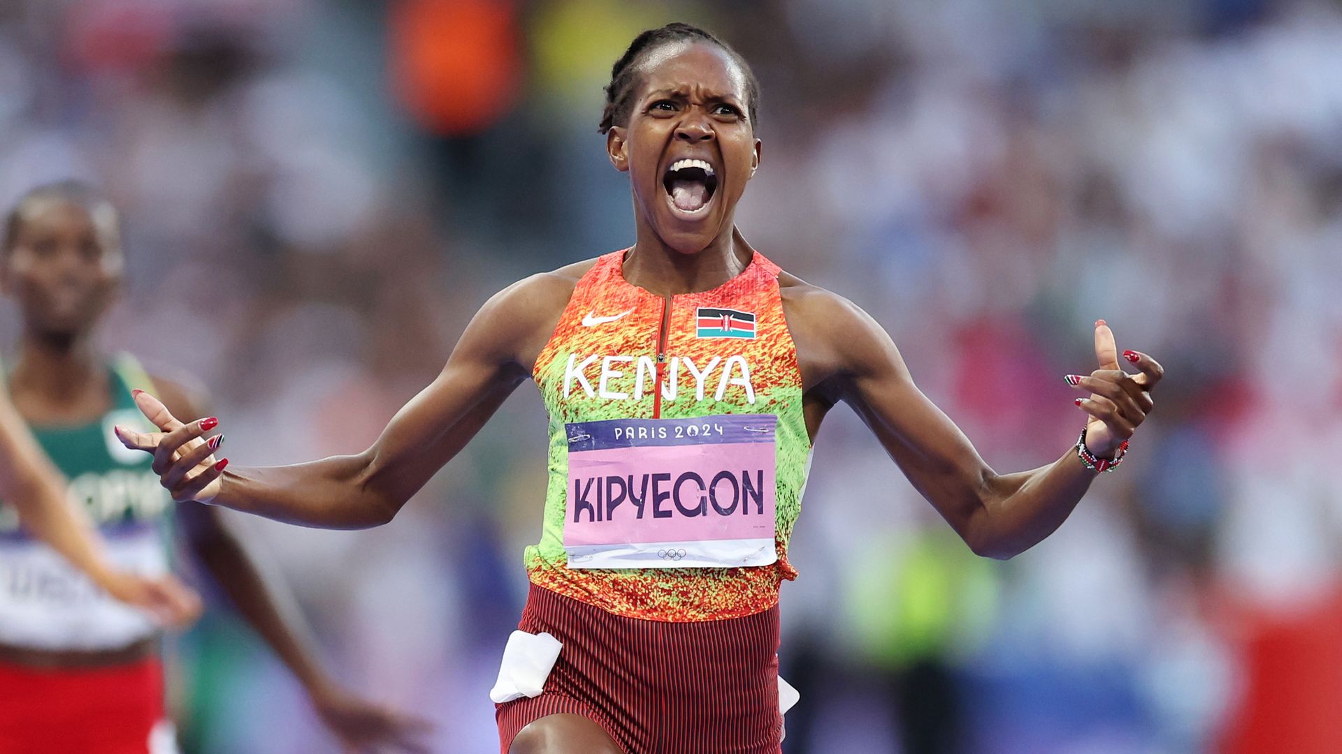 Faith Kipyegon, an olympic runner, celebrates after winning a race.