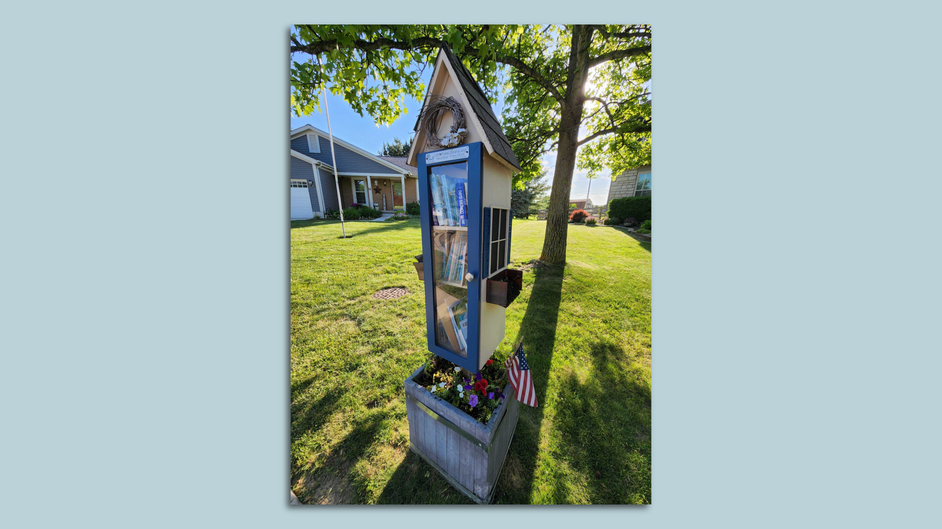 A "Little Free Library" in a front yard.