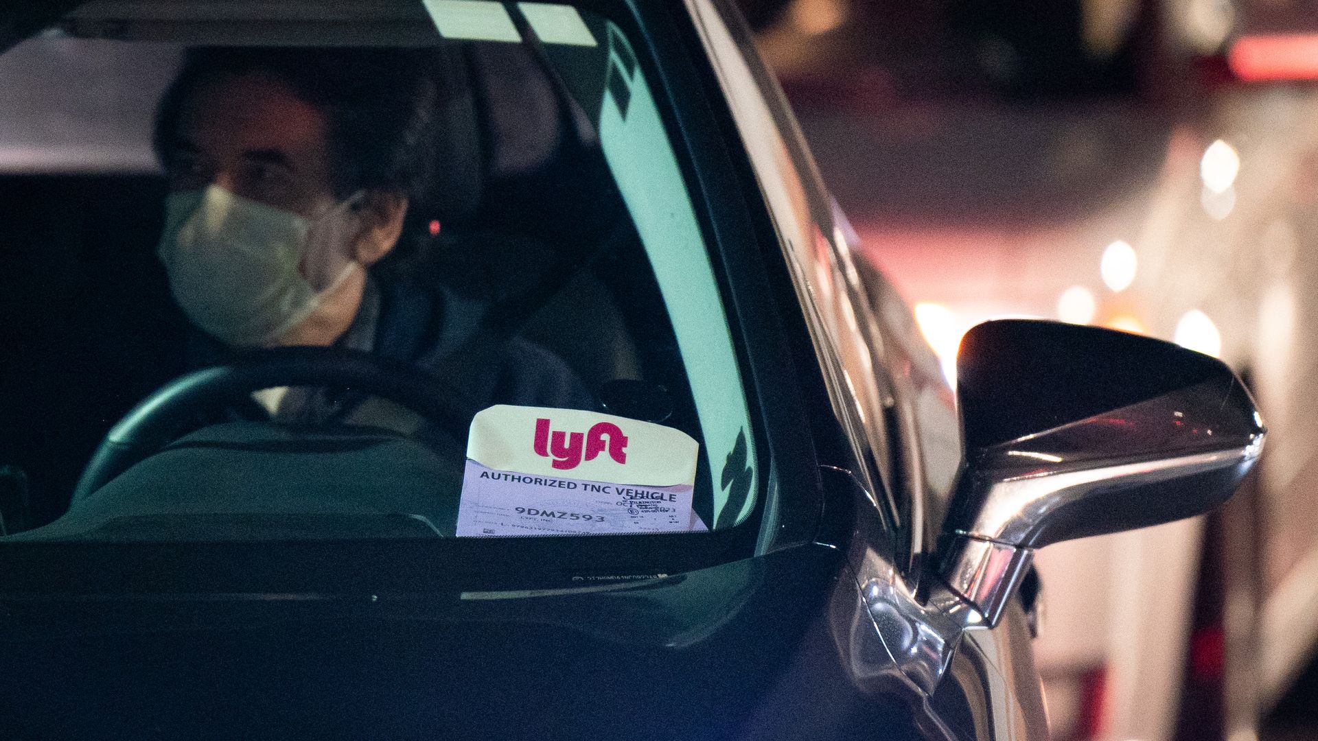 Photo of a driver wearing a mask in a Lyft car during the pandemic