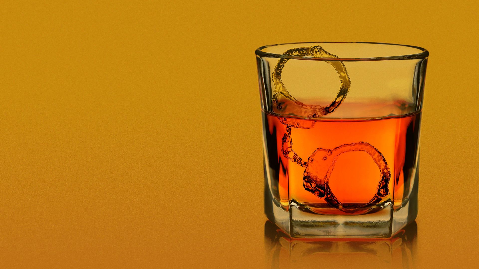Illustration of a glass of whiskey with handcuffs made out of ice. 