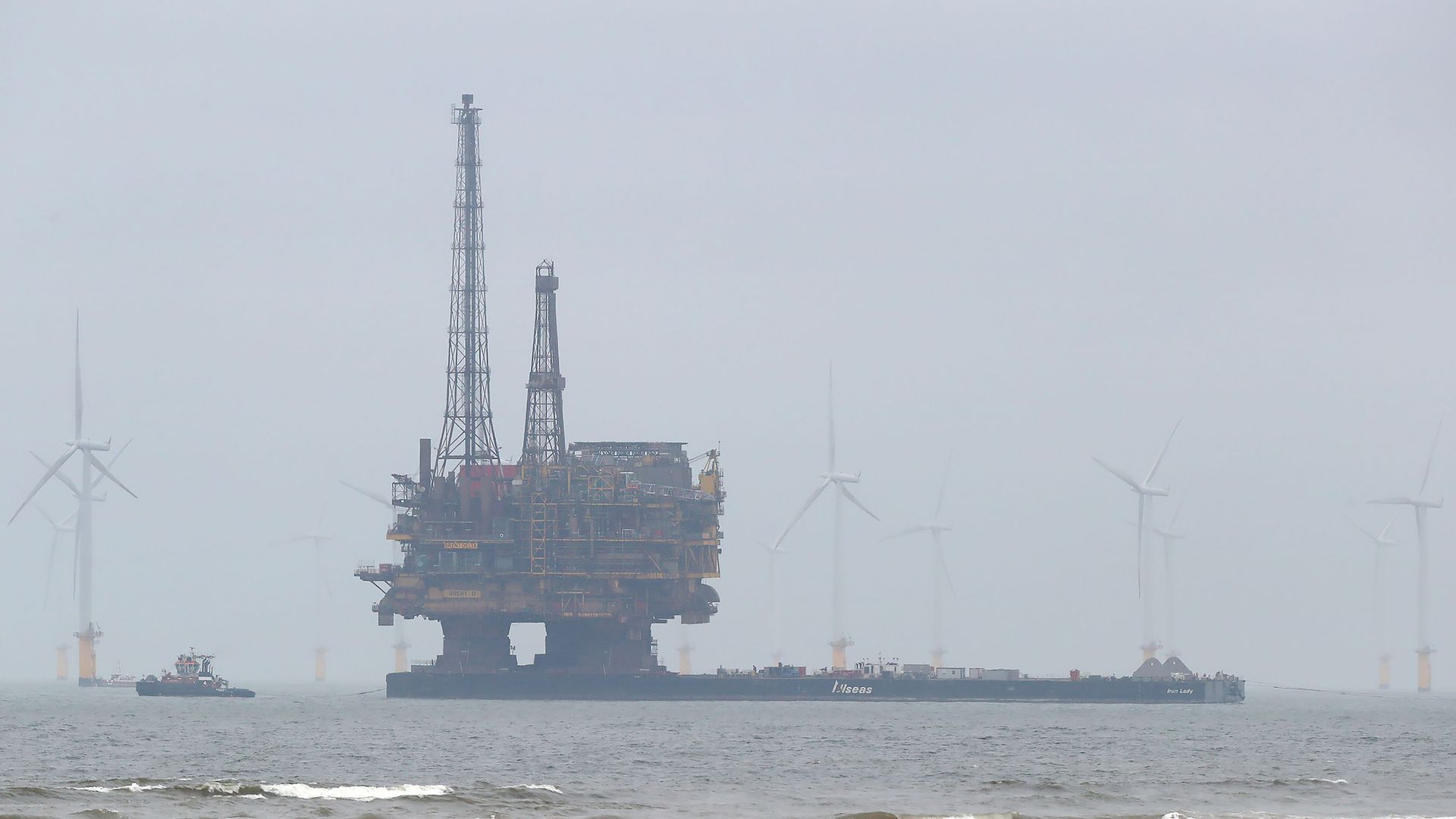 Shell oil rig surrounded by wind turbines