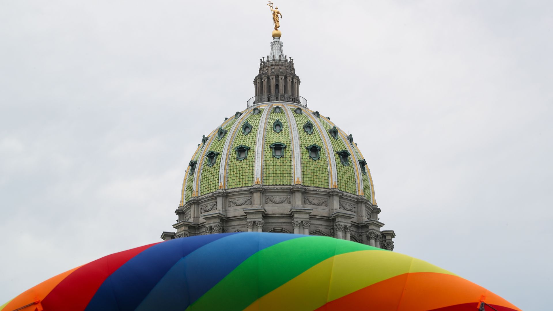 An inflatable rainbow arch is seen outside of the Pennsylvania State Capitol.