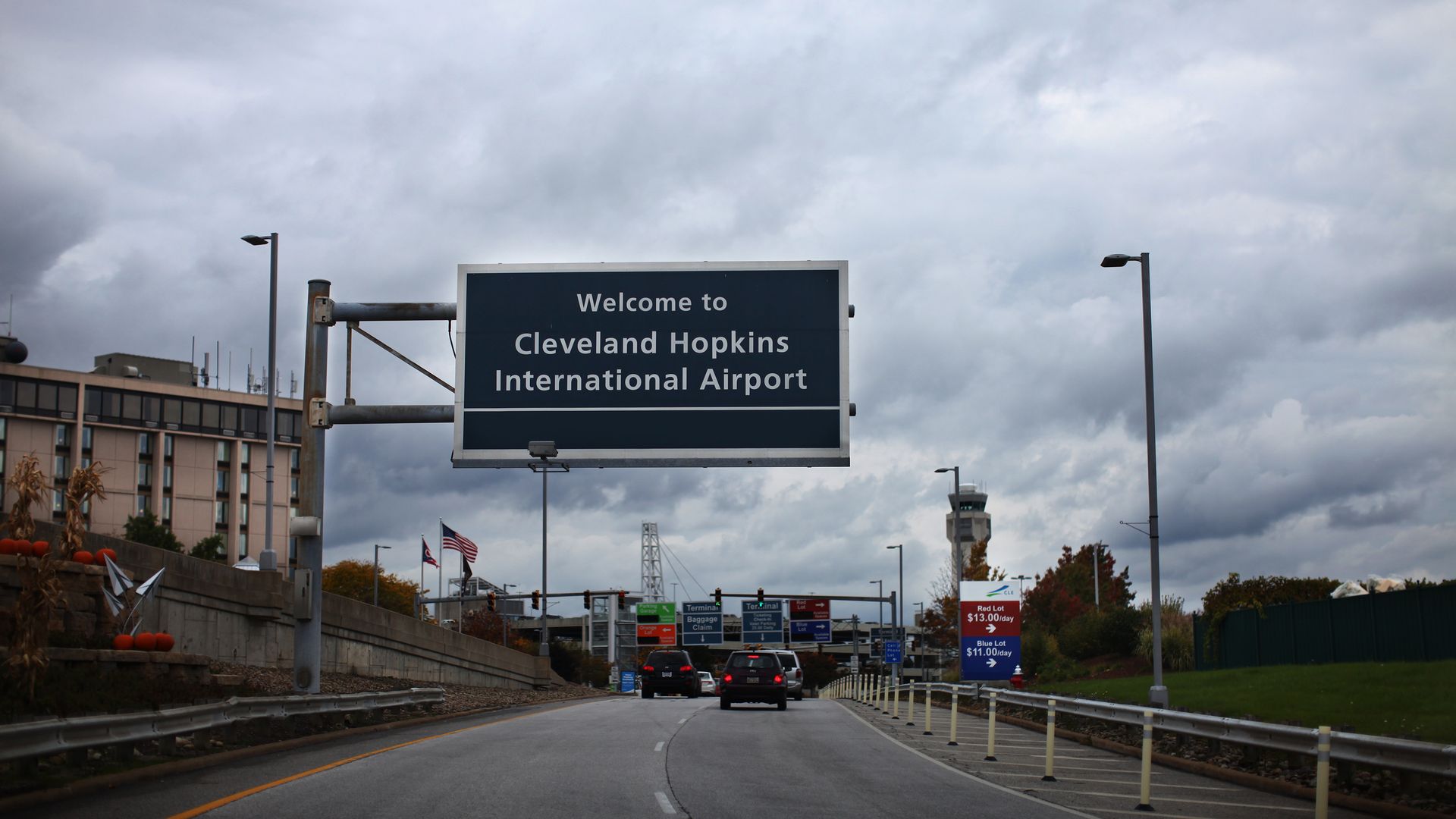 Highway sign reading "Cleveland Hopkins International Airport" overcast sky