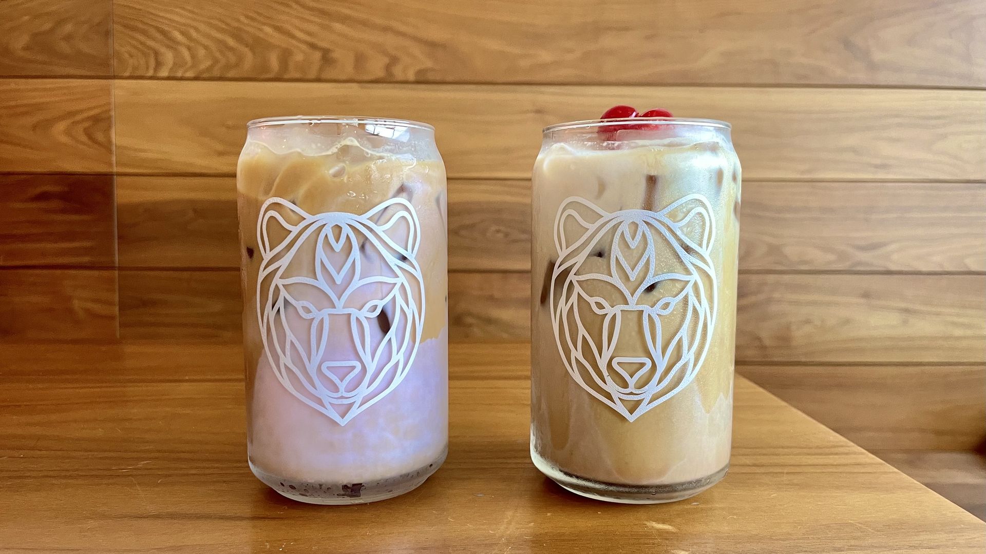 Two iced coffees in glass jars.