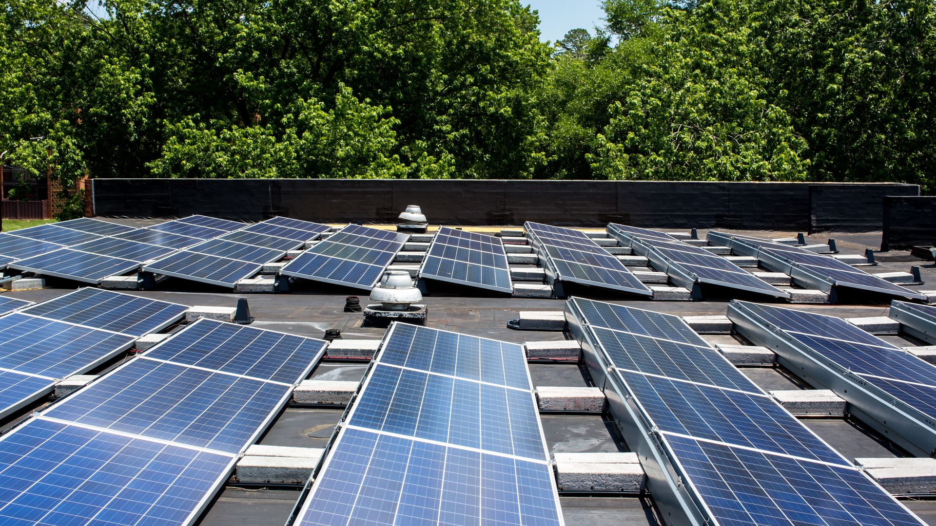 A solar panel array can be seen atop the Aurora Apartments in East Charlotte, NC. Accelerate Solar was hired to install the panels to help offset electrical demand in certain buildings. (Photo by Logan Cyrus for The Washington Post via Getty Images)
