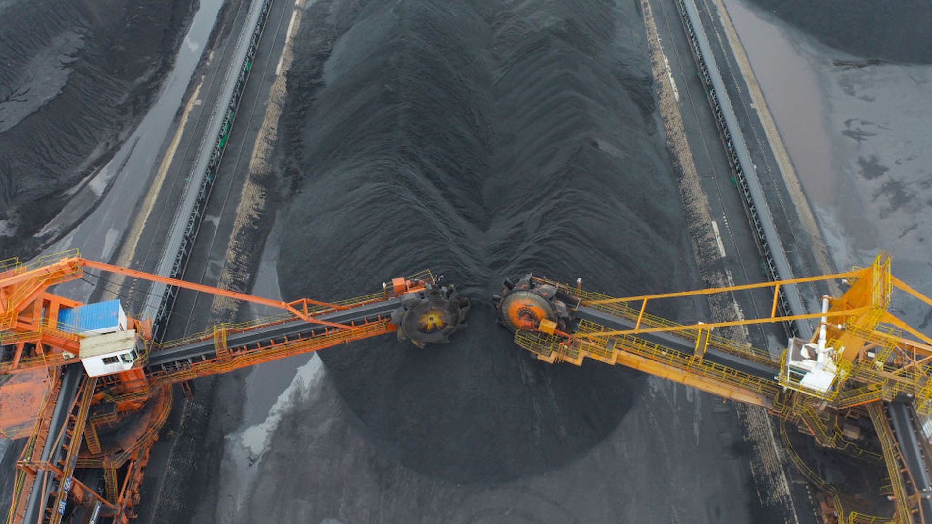 Aerial view of coal being unloaded from a cargo ship at Lianyungang port