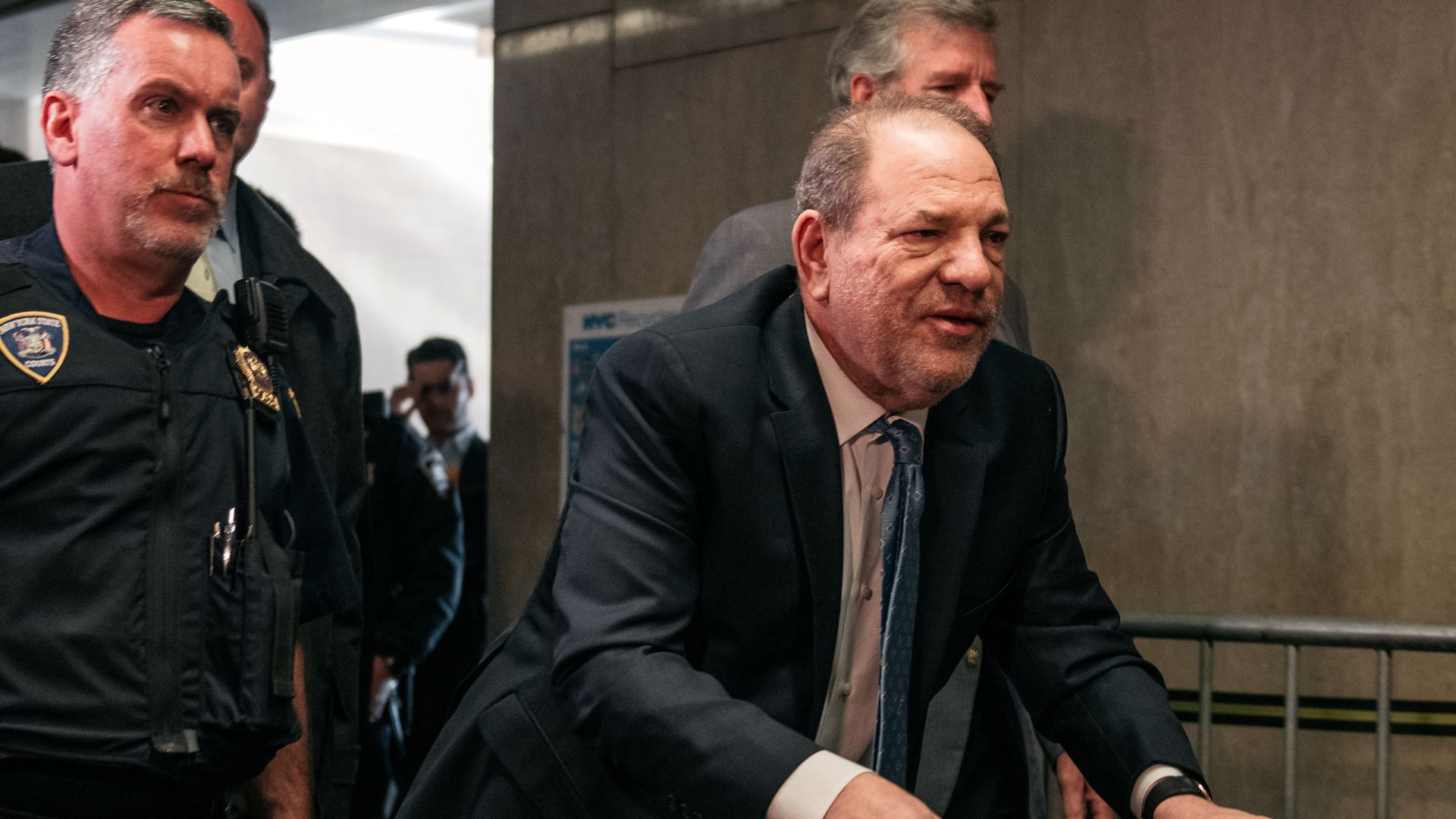Harvey Weinstein walking with a walker.