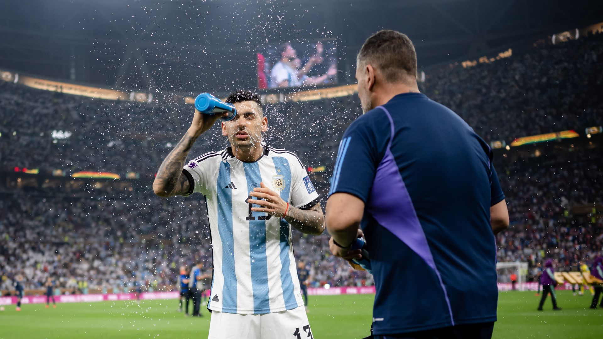 LUSAIL CITY, QATAR - DECEMBER 18: Cristian Romero of Argentina takes some refreshment prior to the FIFA World Cup Qatar 2022 Final match between Argentina and France at Lusail Stadium on December 18, 2022 in Lusail City, Qatar. (Photo by Marvin Ibo Guengoer - GES Sportfoto/Getty Images)
