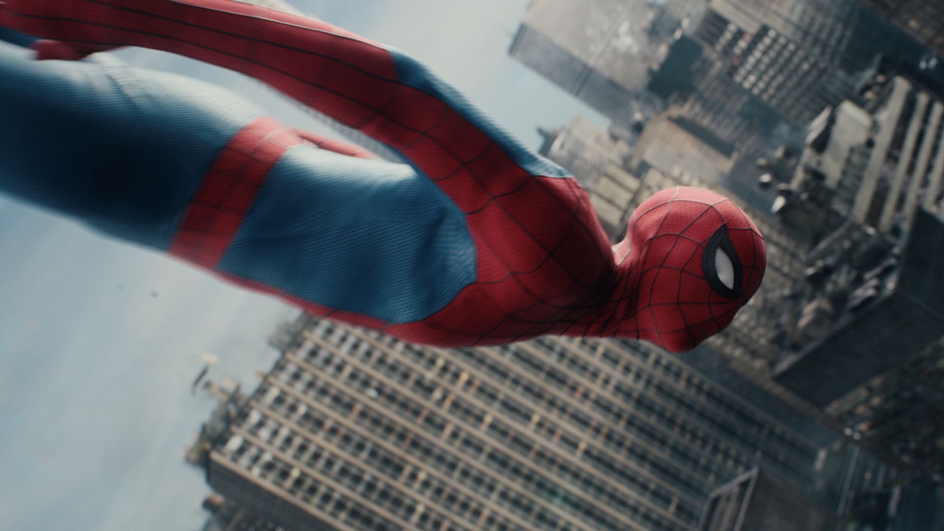 Spider-Man in a red and blue suit swings above a dense city of tall skyscrapers, seen from behind as he glides through the urban skyline.