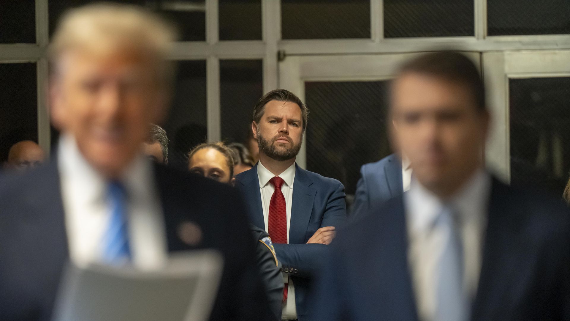  Sen. JD Vance (R-OH) looks on as former President Donald Trump speaks to the media during Trump's trial 