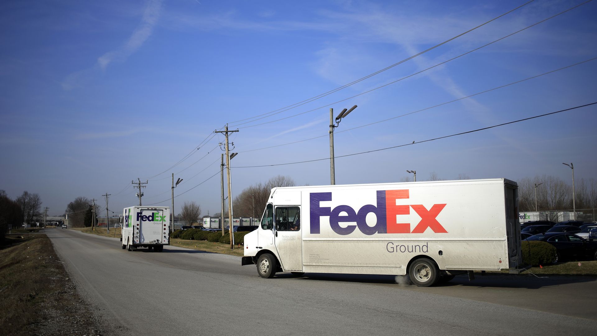 Picture of two FedEx trucks
