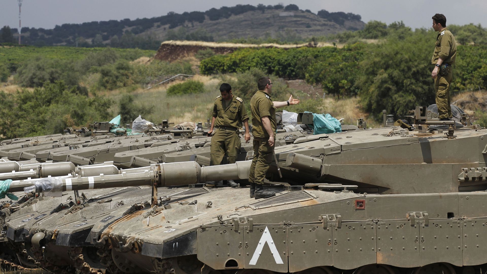sraeli soldiers stands on top of Merkava Mark IV tanks as troops take position near the Syrian border in the Israeli-annexed Golan Heights on May 9, 2018